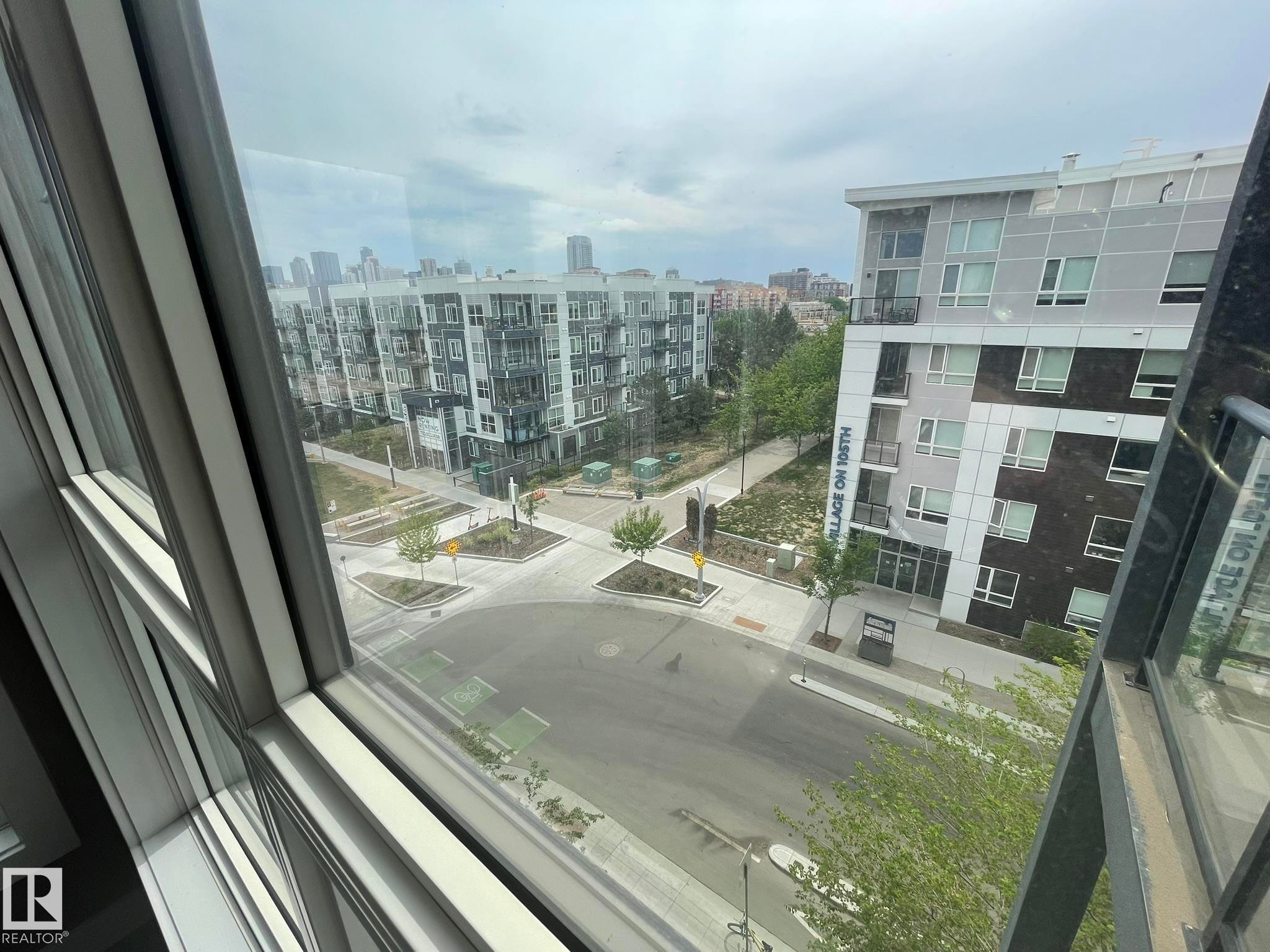Contemporary multi-pane windows frame a urban streetscape - #504 10518 113 St Nw, Edmonton, AB -