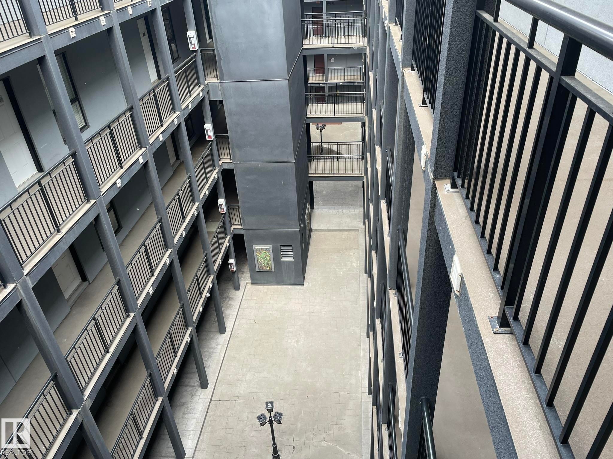 Multi-story building exterior featuring a central courtyard - #504 10518 113 St Nw, Edmonton, AB - With Exterior