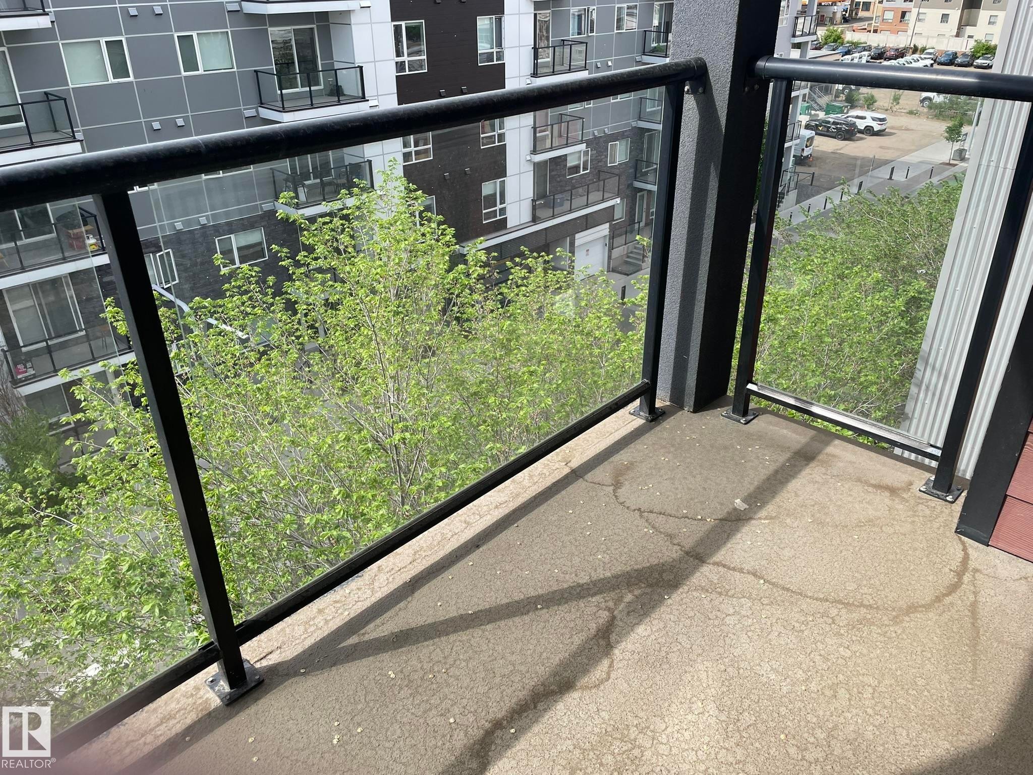 Outdoor balcony space featuring black metal railings with clear glass panels - #504 10518 113 St Nw, Edmonton, AB - Outdoor With Balcony