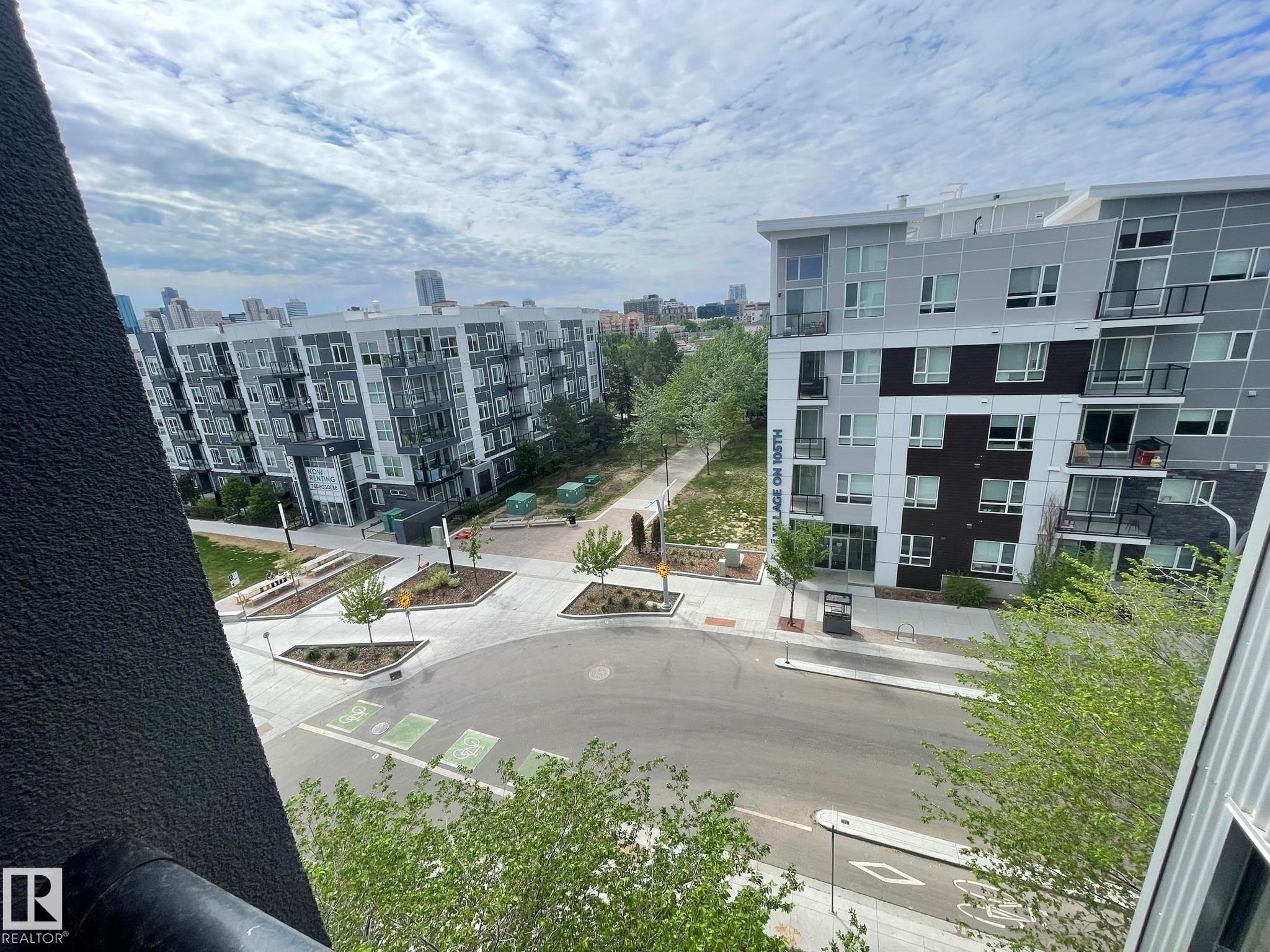 Modern urban streetscape featuring pedestrian pathways, tree-lined sidewalks, and multi-story residential buildings - #504 10518 113 St Nw, Edmonton, AB - Outdoor With Balcony