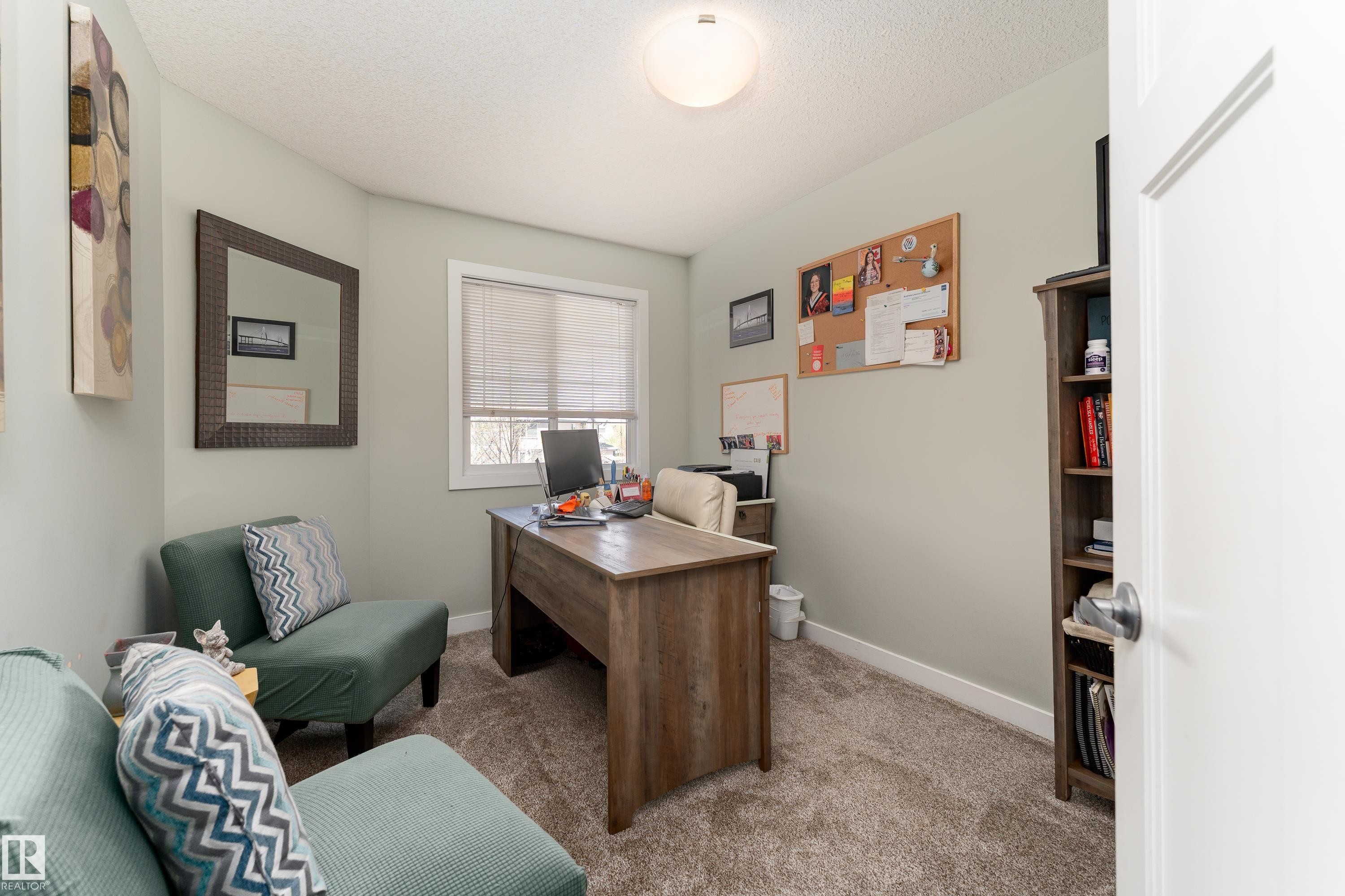 Carpeted room with a textured ceiling and light-colored walls - 16805 55 Street Nw, Edmonton, AB - Indoor Photo Showing Other Room