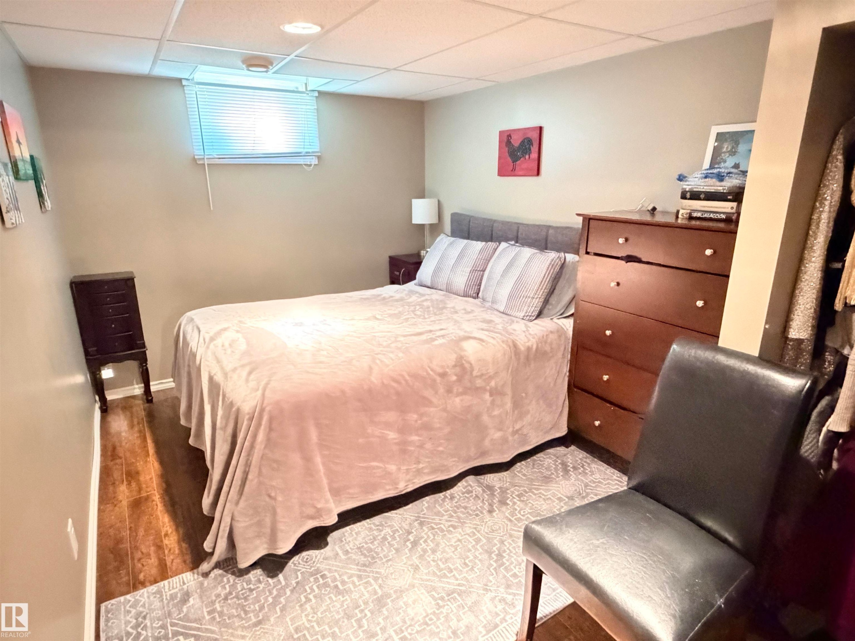 Bedroom with wood-finish flooring, recessed lighting, and a drop ceiling - 4823 49 Street, Clyde, AB - Indoor Photo Showing Bedroom