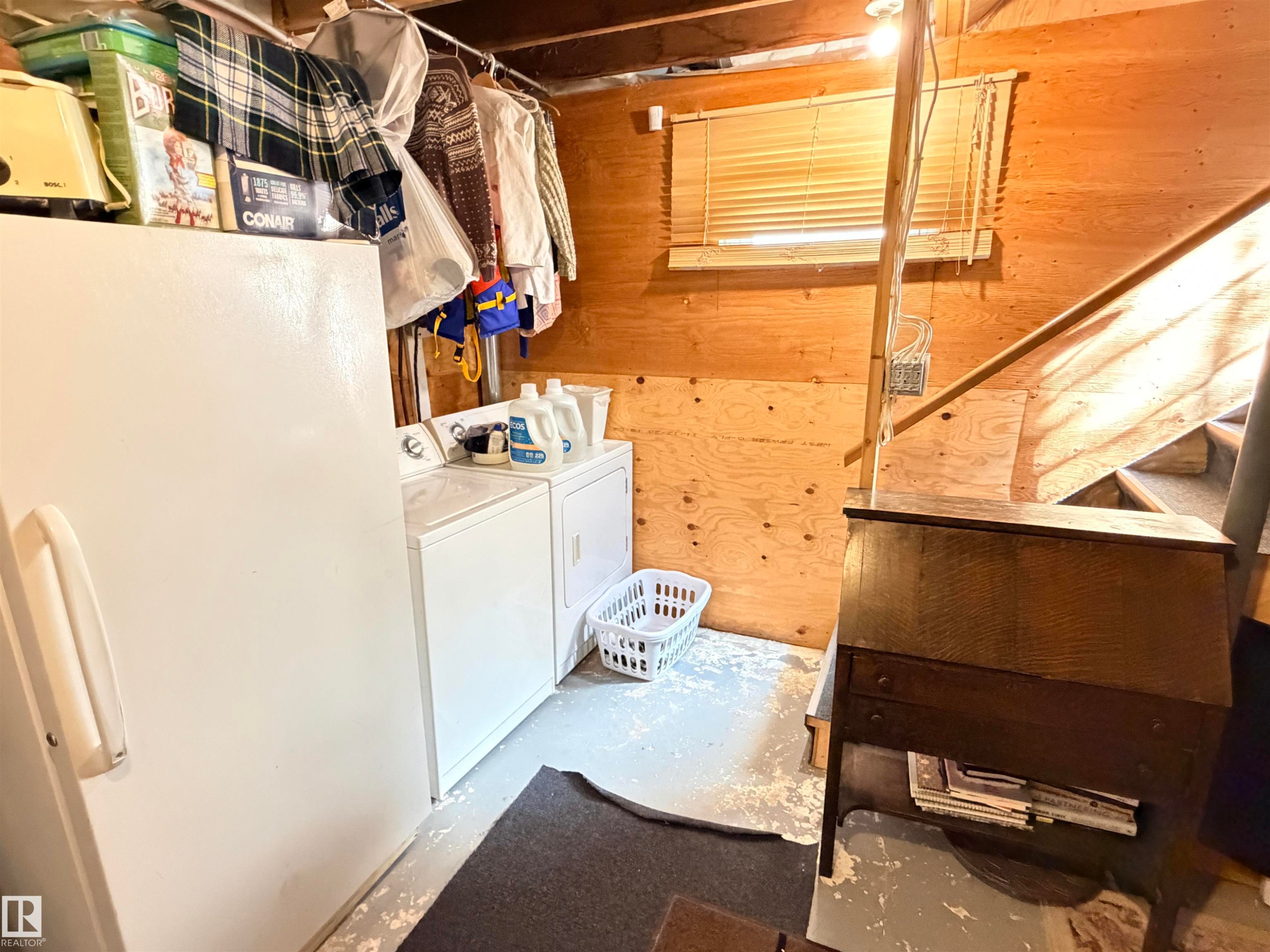 Utility area with white appliances and wood-paneled walls - 4823 49 Street, Clyde, AB - Indoor Photo Showing Laundry Room