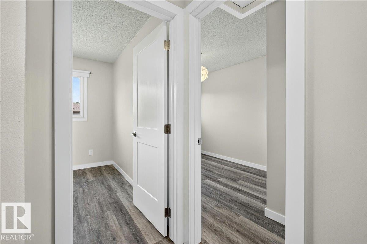 Interior doorways showcasing modern panel doors and wood-finish flooring - 4212 32 Avenue Nw, Edmonton, AB - Indoor Photo Showing Other Room