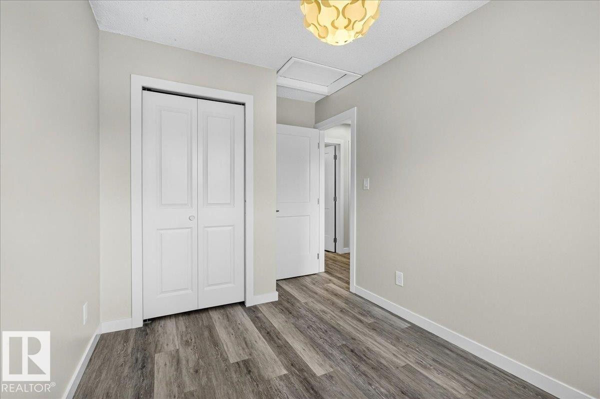 Interior room featuring wood-finish flooring and light-toned walls - 4212 32 Avenue Nw, Edmonton, AB - Indoor Photo Showing Other Room