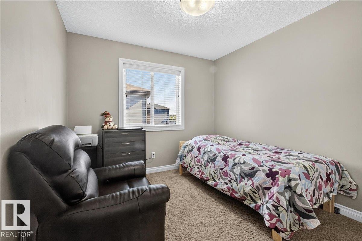 Room featuring a window with horizontal blinds, neutral wall paint, and light brown carpeting - 5110 168A Avenue Nw, Edmonton, AB - Indoor Photo Showing Bedroom