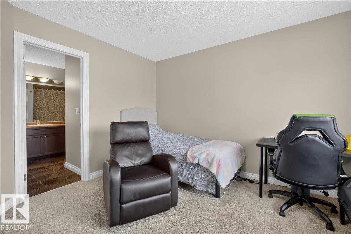 Neutral-toned room featuring light-colored carpeting and white baseboards - 5110 168A Avenue Nw, Edmonton, AB - Indoor