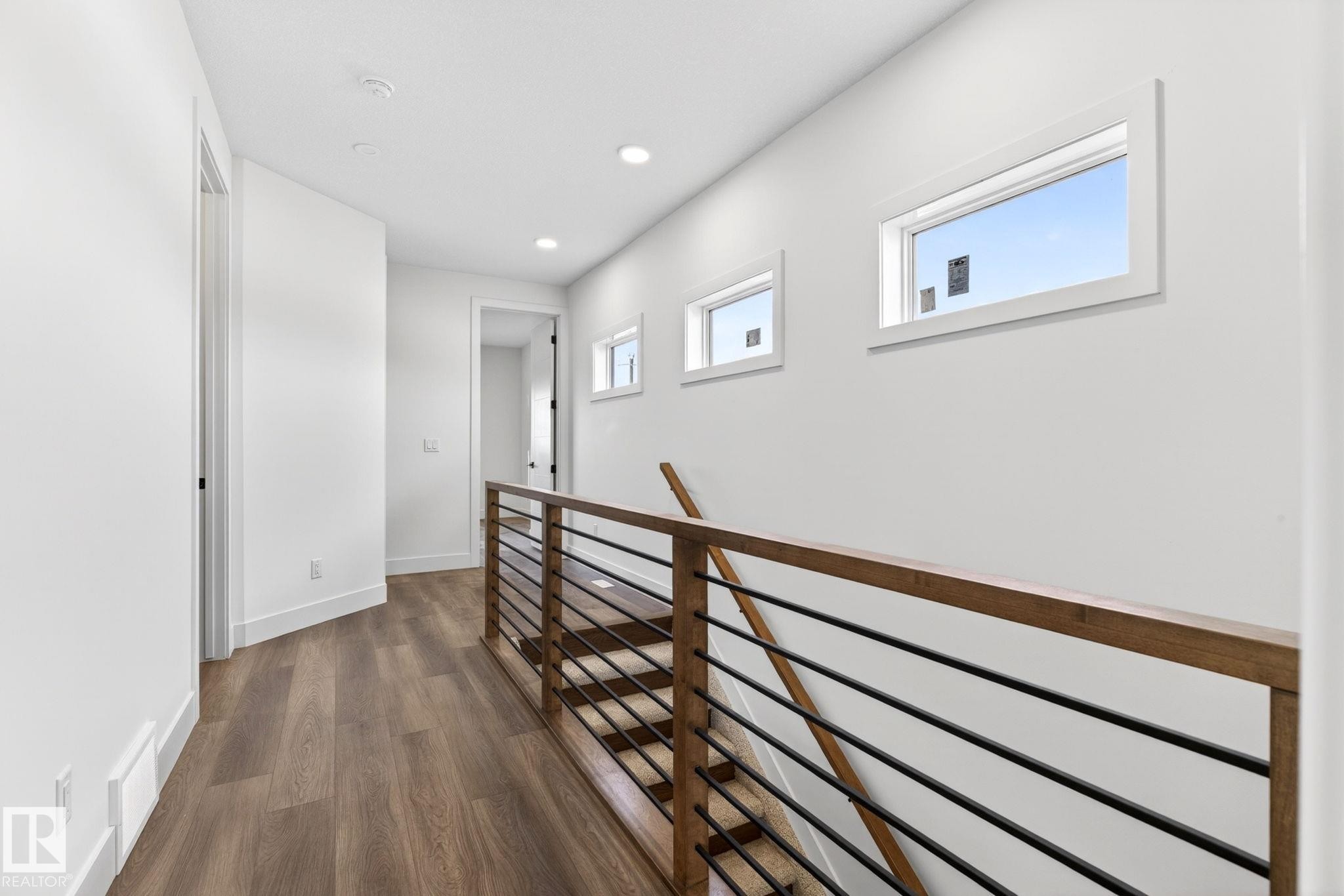Upper-level hallway with wood-finish flooring, recessed lighting, and white walls - 5308 103A Avenue, Edmonton, AB - Indoor Photo Showing Other Room