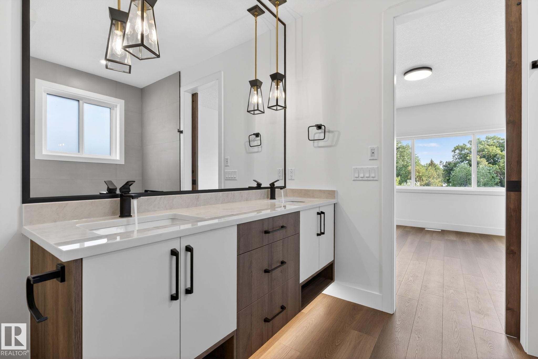Dual vanity with matte black fixtures and white countertops - 5308 103A Avenue, Edmonton, AB - Indoor Photo Showing Bathroom