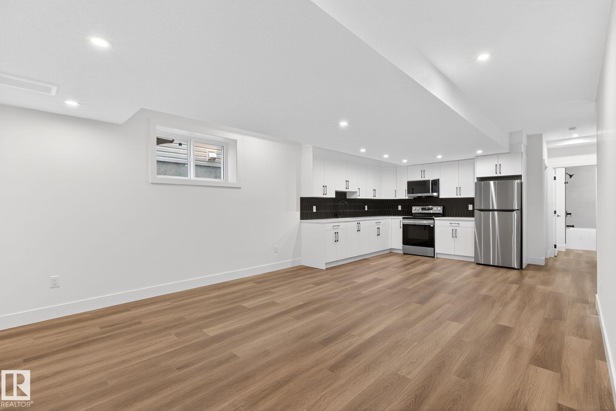 Open-concept living area featuring wood-finish flooring and recessed lighting - 5308 103A Avenue, Edmonton, AB - Indoor Photo Showing Kitchen