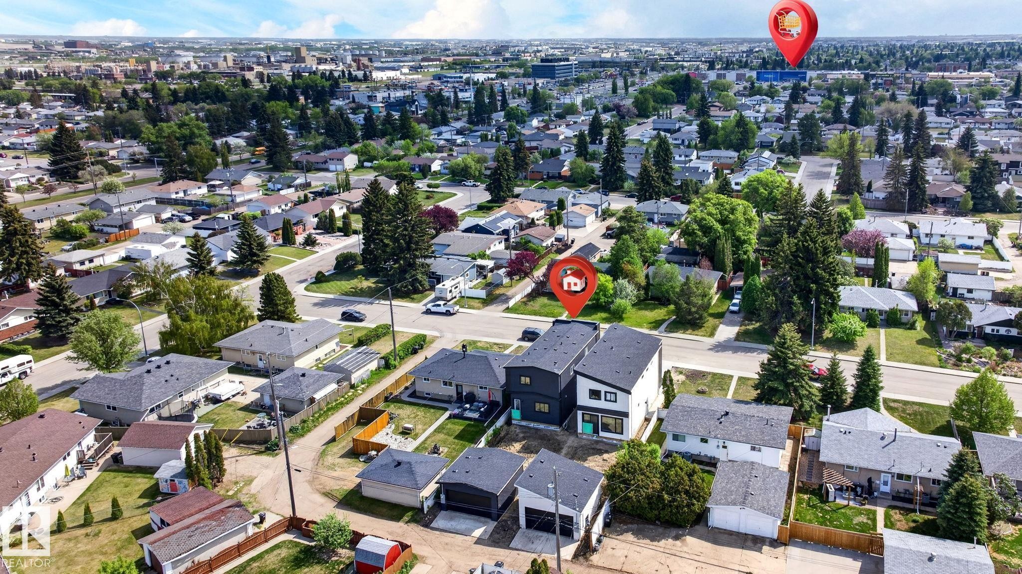Contemporary townhomes featuring contrasting dark and light exteriors, prominent square windows, and a flat roofline - 5308 103A Avenue, Edmonton, AB - Outdoor With View