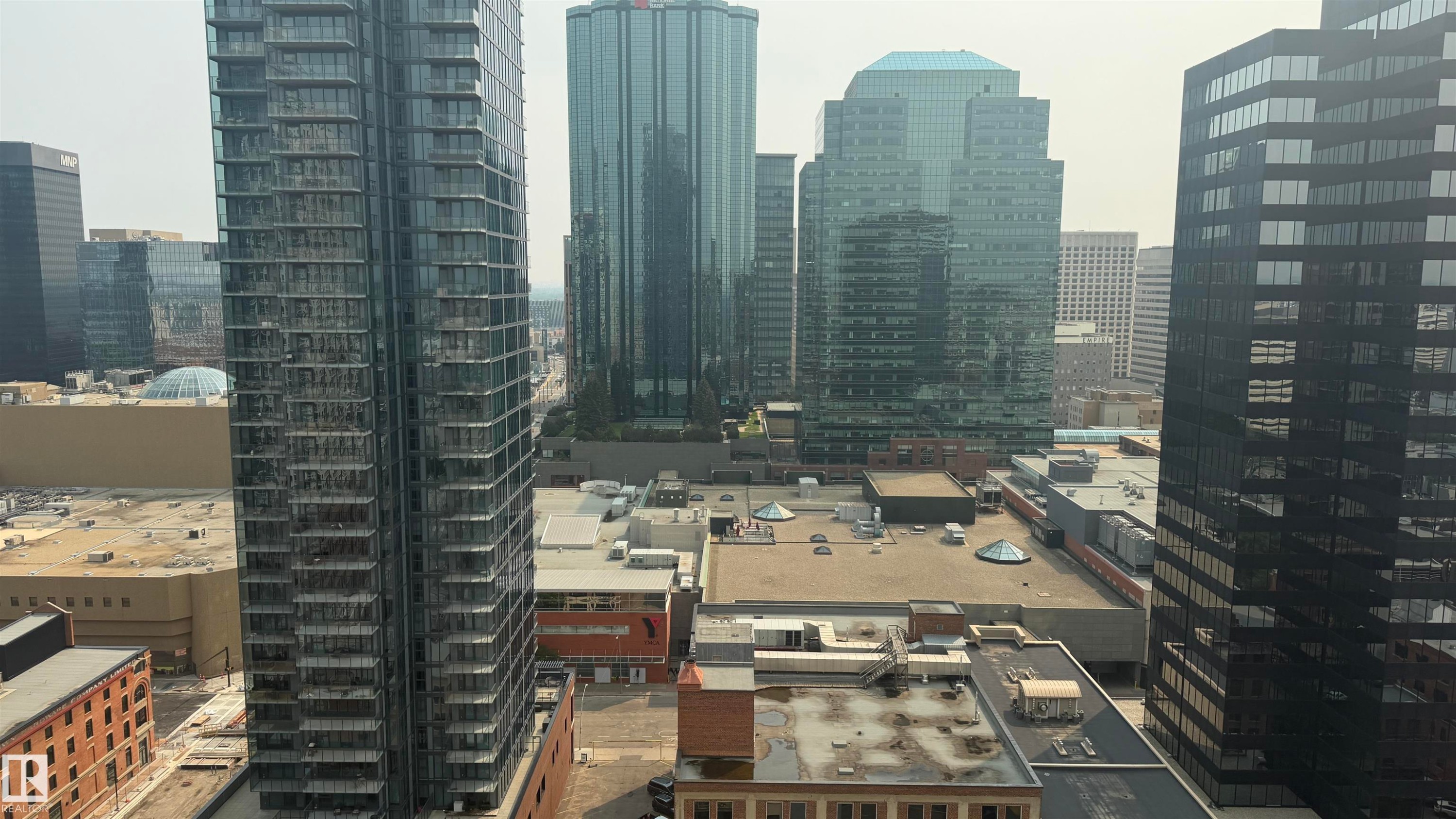 High-rise urban landscape featuring multiple glass-clad buildings and varied architectural styles - #2401 10180 104 St Nw, Edmonton, AB - Outdoor