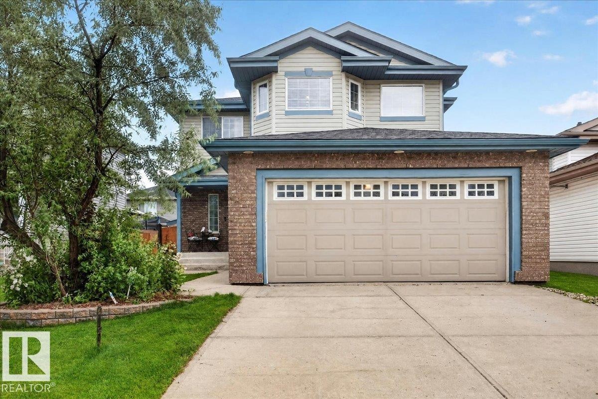 Two-story home with a two-car garage, featuring light brick accents and neutral siding - 6 Norfolk Close, St. Albert, AB - Outdoor
