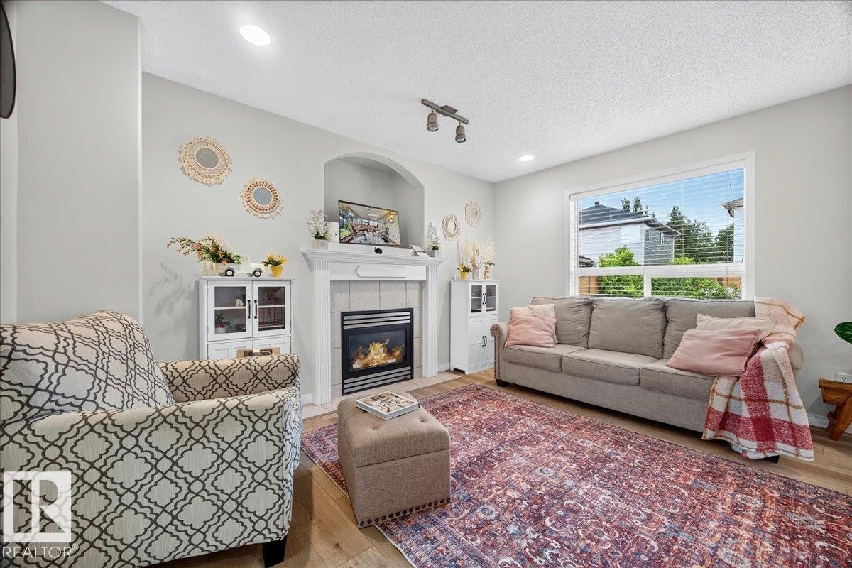 Living area featuring light wood-finish flooring and recessed lighting - 6 Norfolk Close, St. Albert, AB - Indoor Photo Showing Living Room With Fireplace