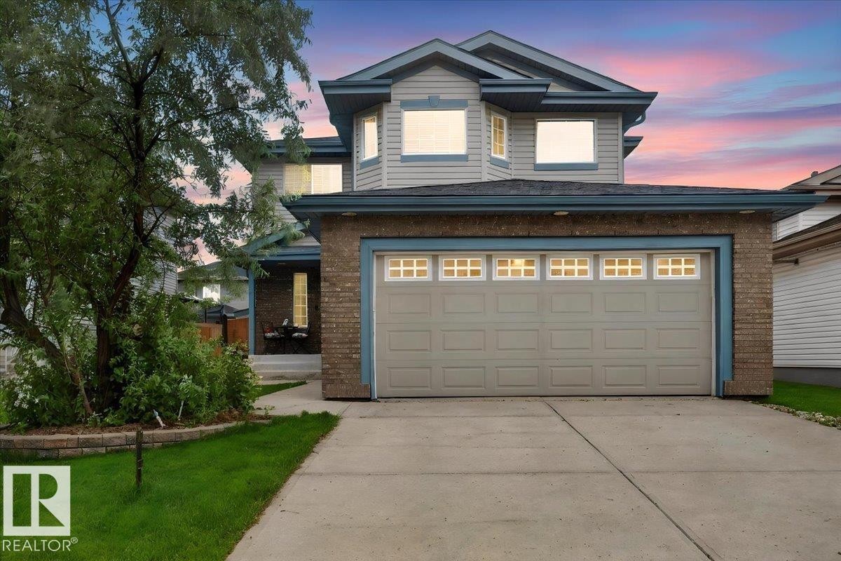 Two-story property featuring light gray siding with brick accents and blue trim - 6 Norfolk Close, St. Albert, AB - Outdoor