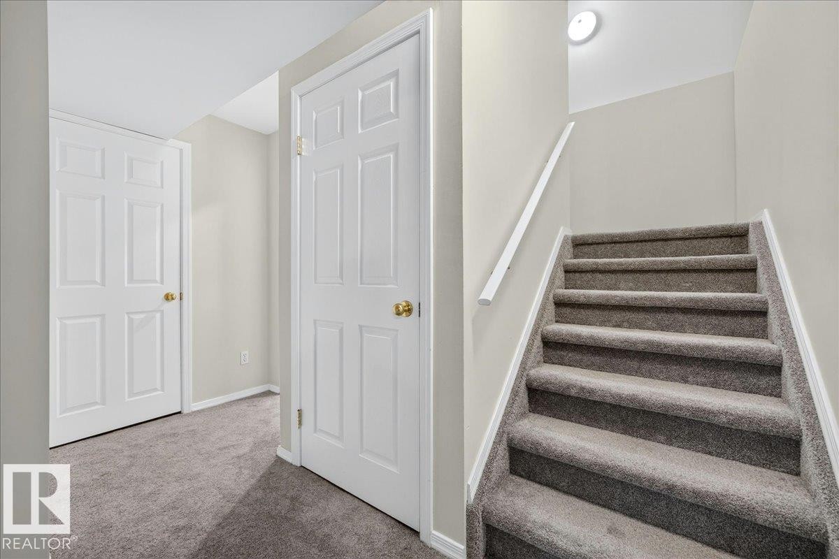 Carpeted staircase with white handrail and trim - 6 Norfolk Close, St. Albert, AB - Indoor Photo Showing Other Room