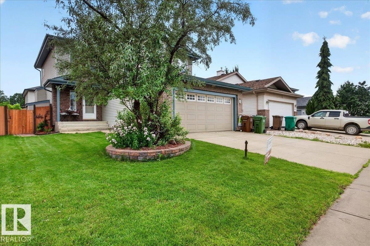 Two-story residence featuring a brick facade accent, attached two-car garage, and a concrete driveway - 6 Norfolk Close, St. Albert, AB - Outdoor
