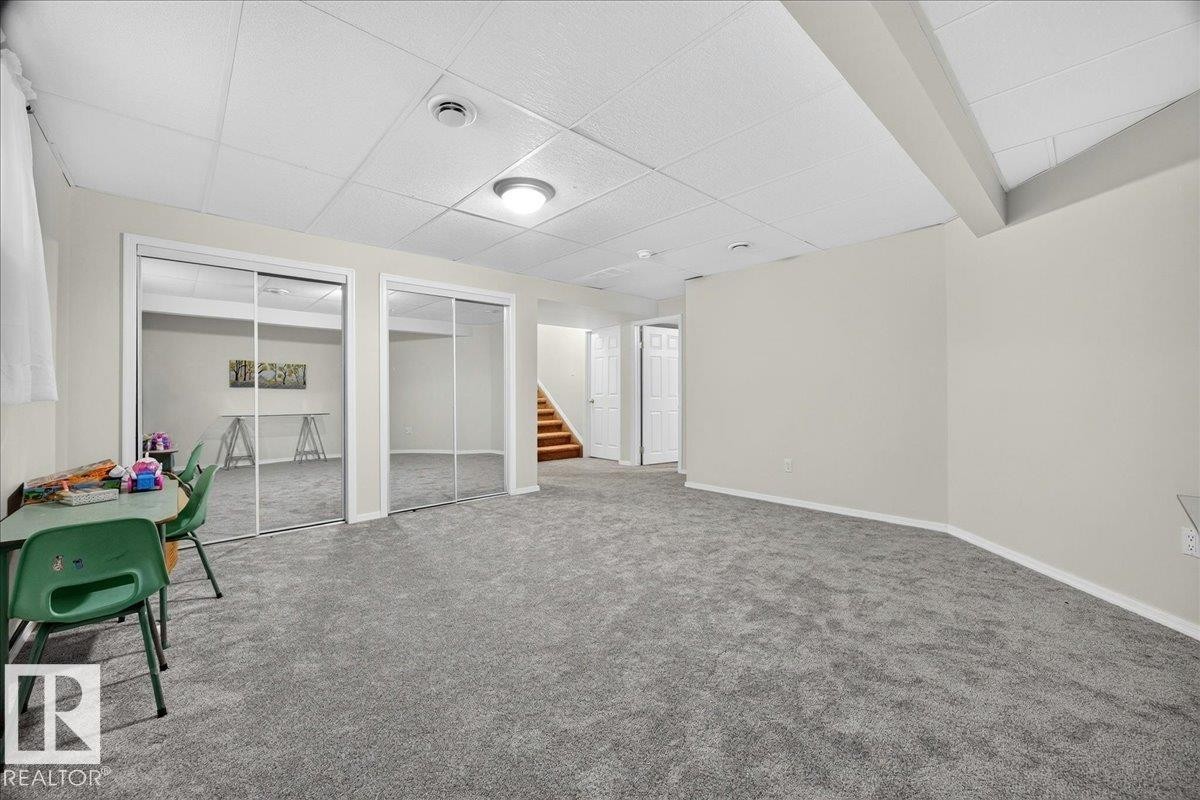 Spacious room featuring neutral wall paint and gray carpeting - 6 Norfolk Close, St. Albert, AB - Indoor Photo Showing Other Room
