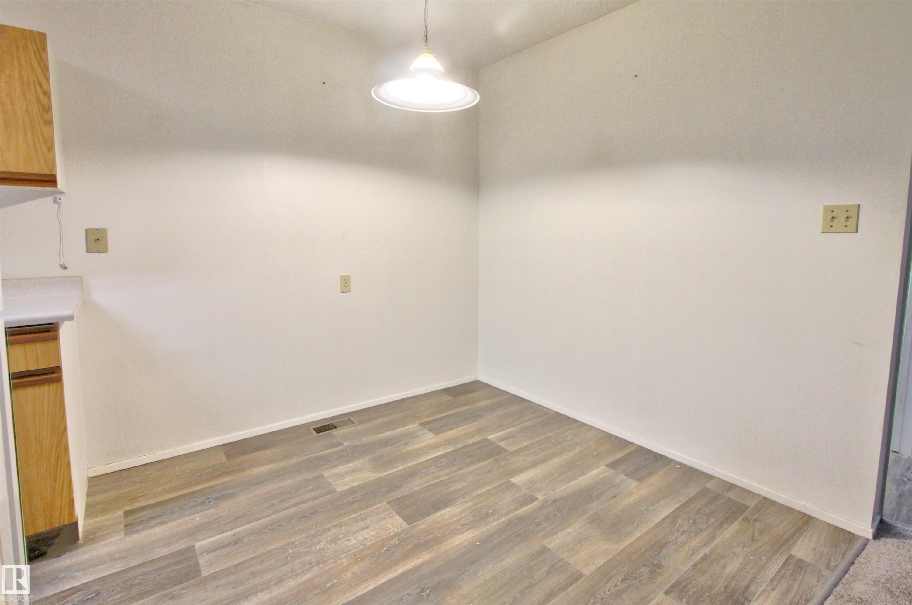 Light wood-finish flooring complements crisp white walls - #302 47 Akins Dr, St. Albert, AB - Indoor Photo Showing Other Room