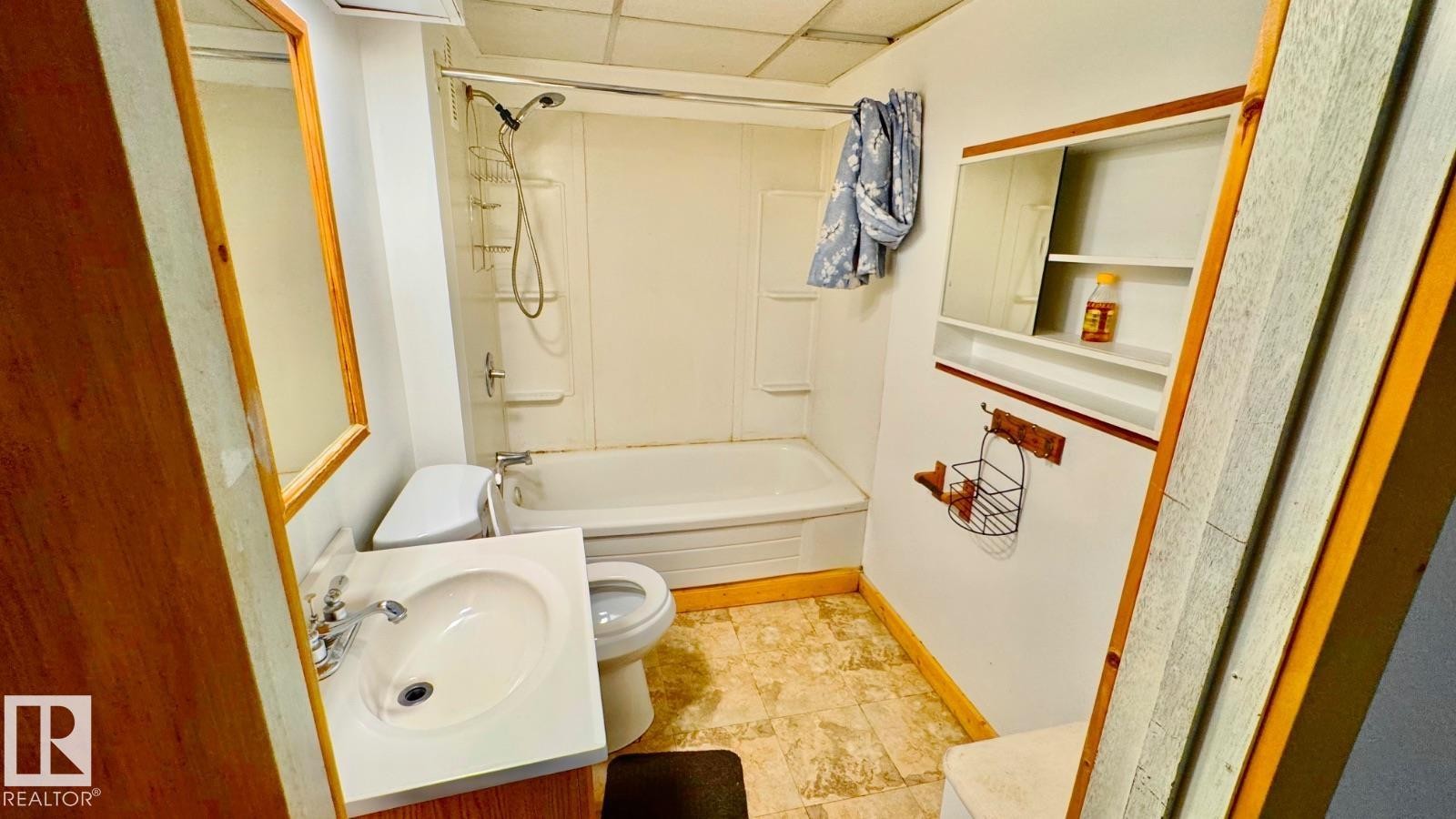 Full bathroom featuring a white vanity with integrated sink, chrome faucet, and wood-finish cabinetry - 5144 37 Avenue Nw, Edmonton, AB - Indoor Photo Showing Bathroom