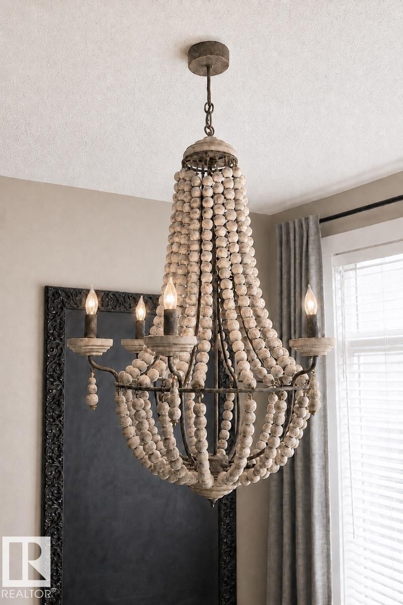 Beaded chandelier with candelabra lights, featuring an aged metal frame and light wood-tone beads - 2337 Frezenberg Avenue Nw, Edmonton, AB - Indoor Photo Showing Other Room