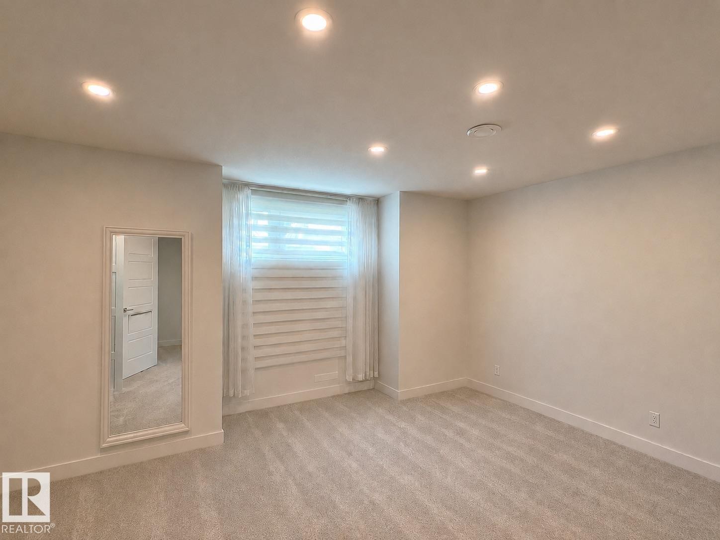 Recessed lighting illuminates a neutral-toned room with plush carpet flooring - 2337 Frezenberg Avenue Nw, Edmonton, AB - Indoor