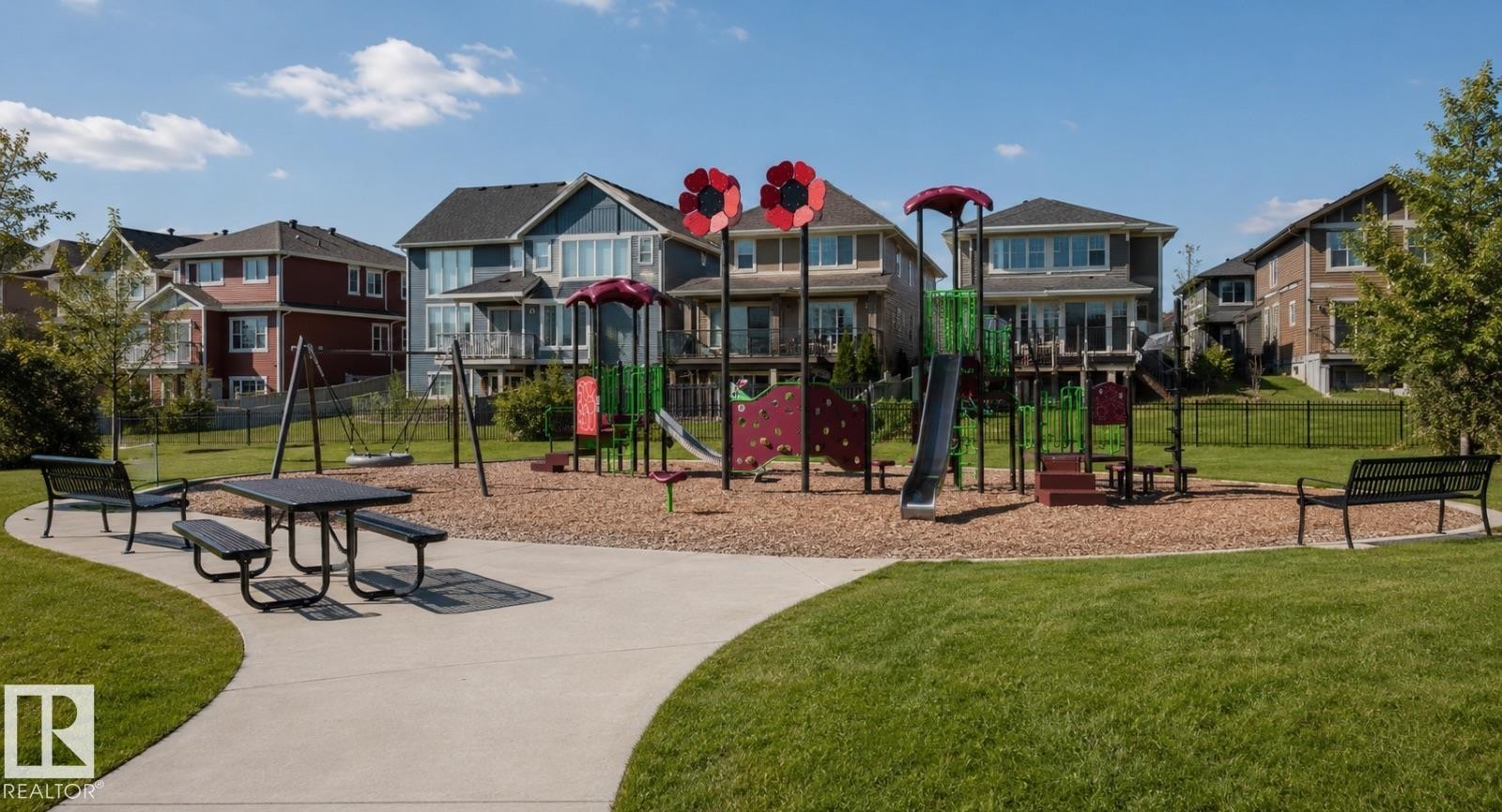 Community park featuring a playground with slides and swings, a picnic table, and benches - 2337 Frezenberg Avenue Nw, Edmonton, AB - Outdoor