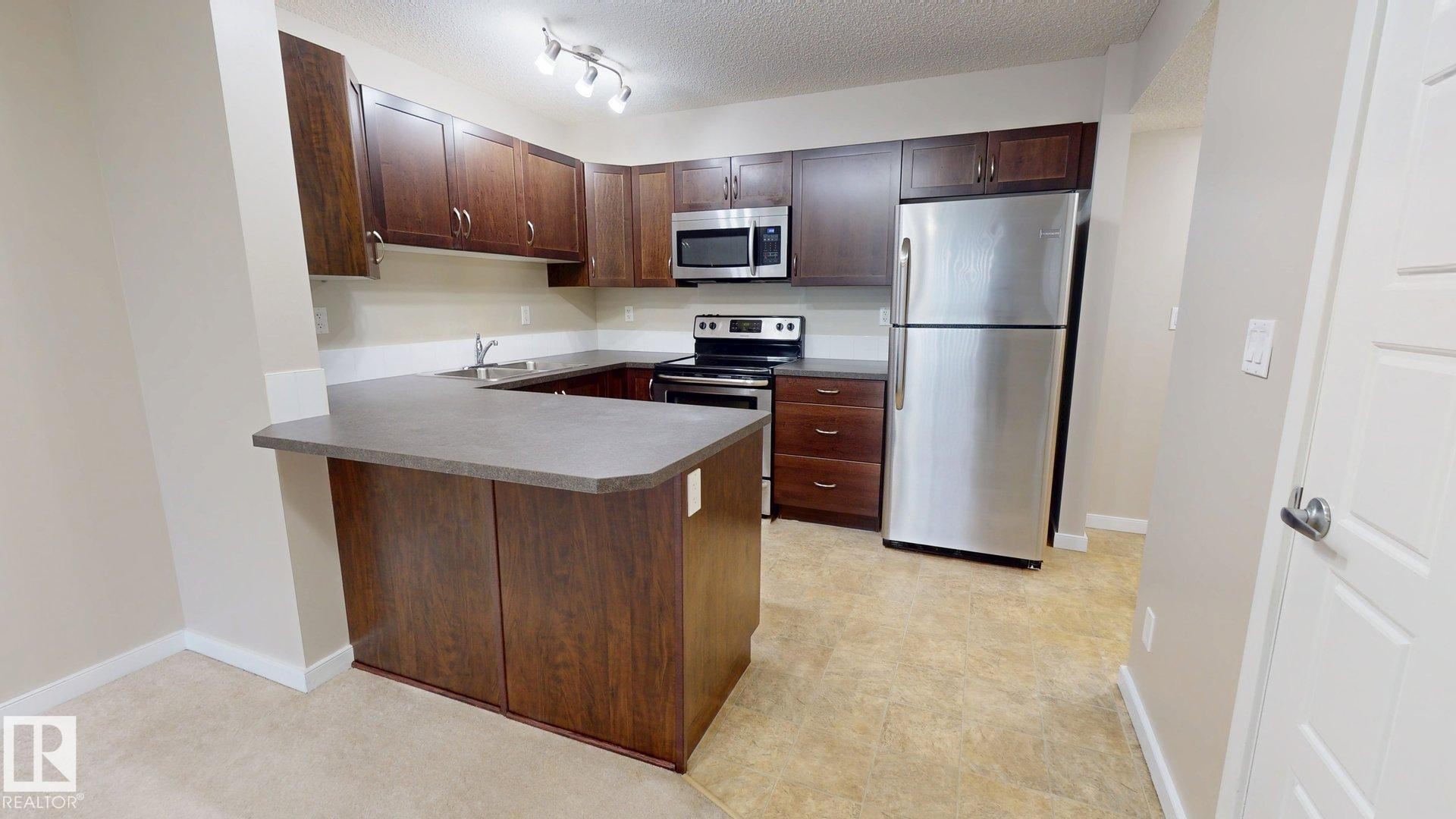 #213 396 Silver Berry Rd Nw, Edmonton, AB - Indoor Photo Showing Kitchen With Stainless Steel Kitchen