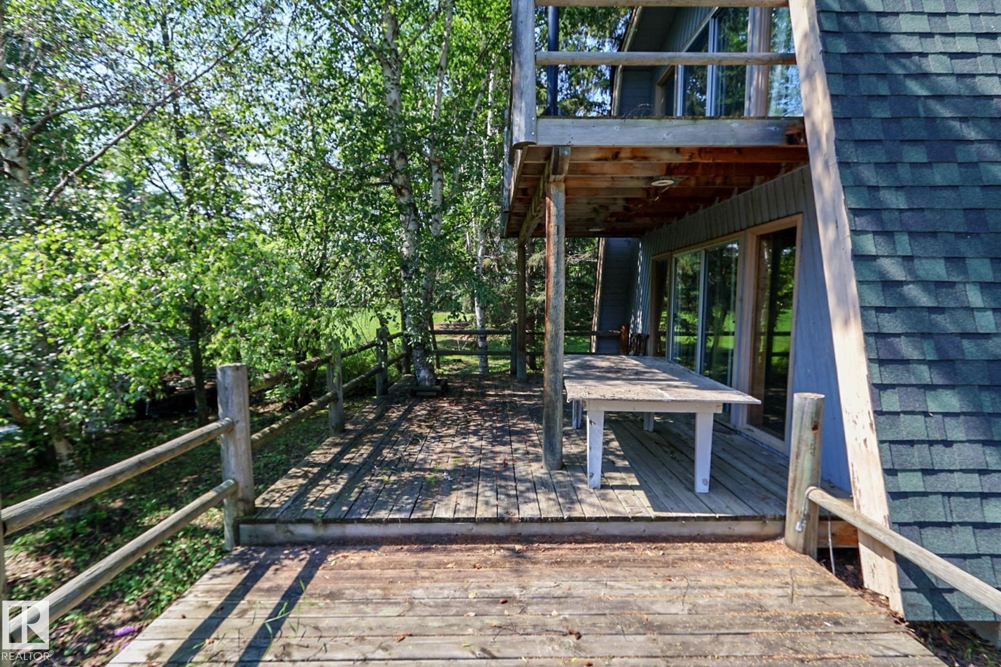Multi-level wooden deck featuring a rustic railing system - 329 60417 Range Road 124, Rural St. Paul County, AB - Outdoor