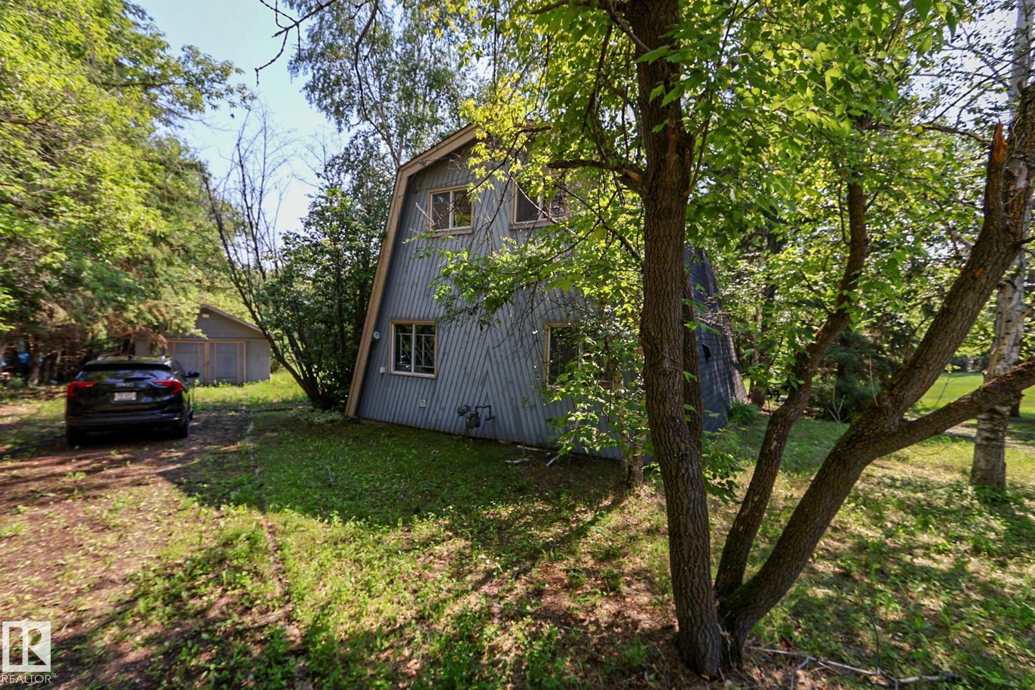 A-frame style residence featuring vertical siding and multiple windows - 329 60417 Range Road 124, Rural St. Paul County, AB - Outdoor