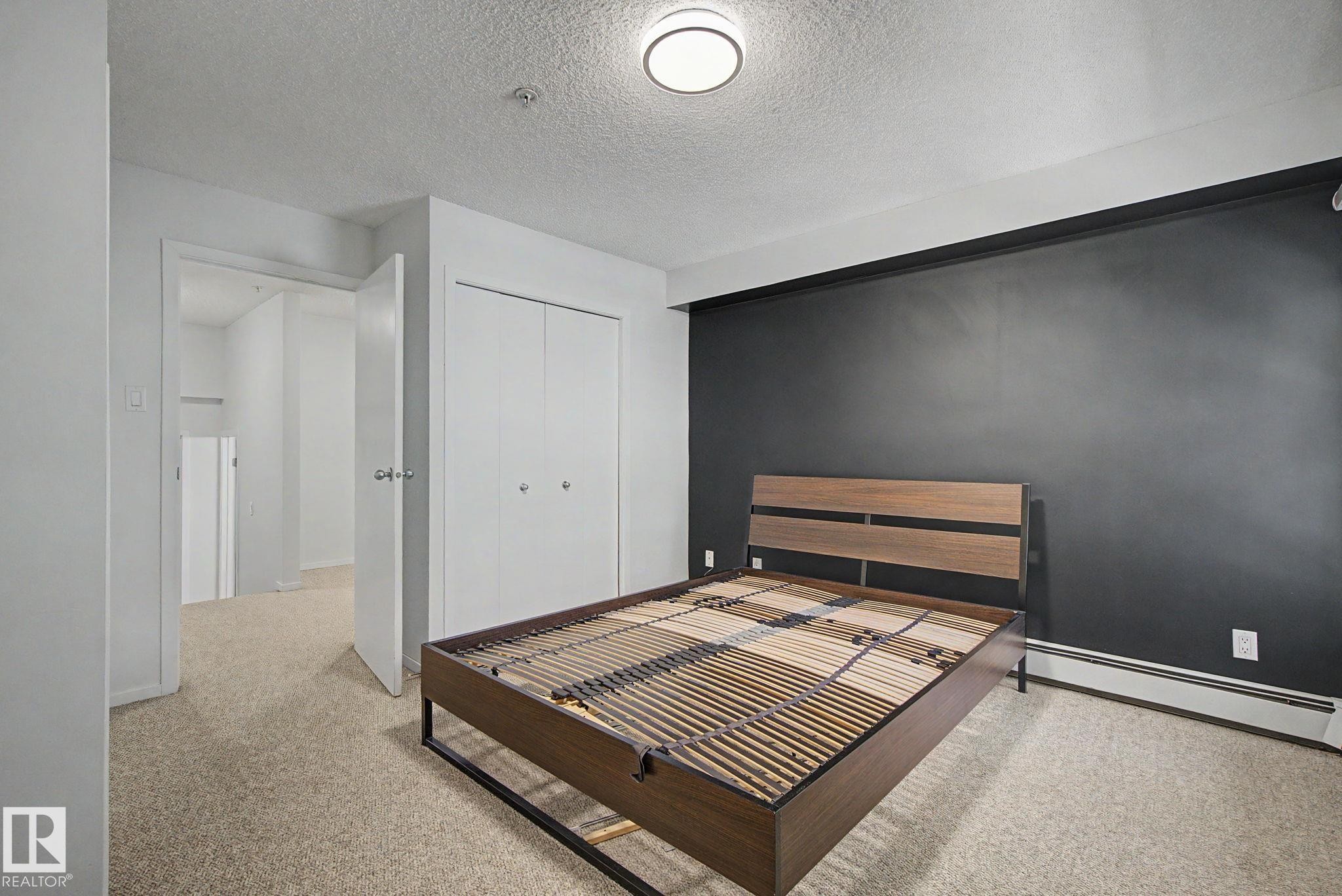 Interior room featuring a neutral carpet flooring and white walls - 11150 83 Avenue Nw, Edmonton, AB