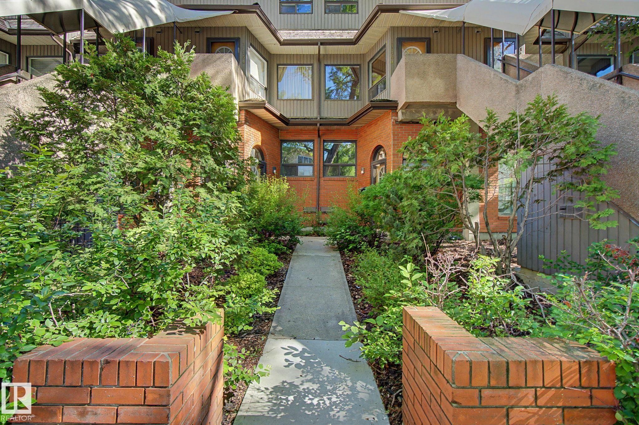 Multi-story exterior with brick and panel siding - 11150 83 Avenue Nw, Edmonton, AB