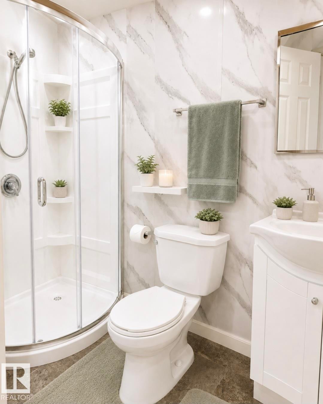 Bathroom featuring a curved glass shower enclosure, white marble-look wall panels, a white toilet, a white vanity with an integrated sink, and a framed mirror - 3236 27 Avenue Nw, Edmonton, AB - Indoor Photo Showing Bathroom