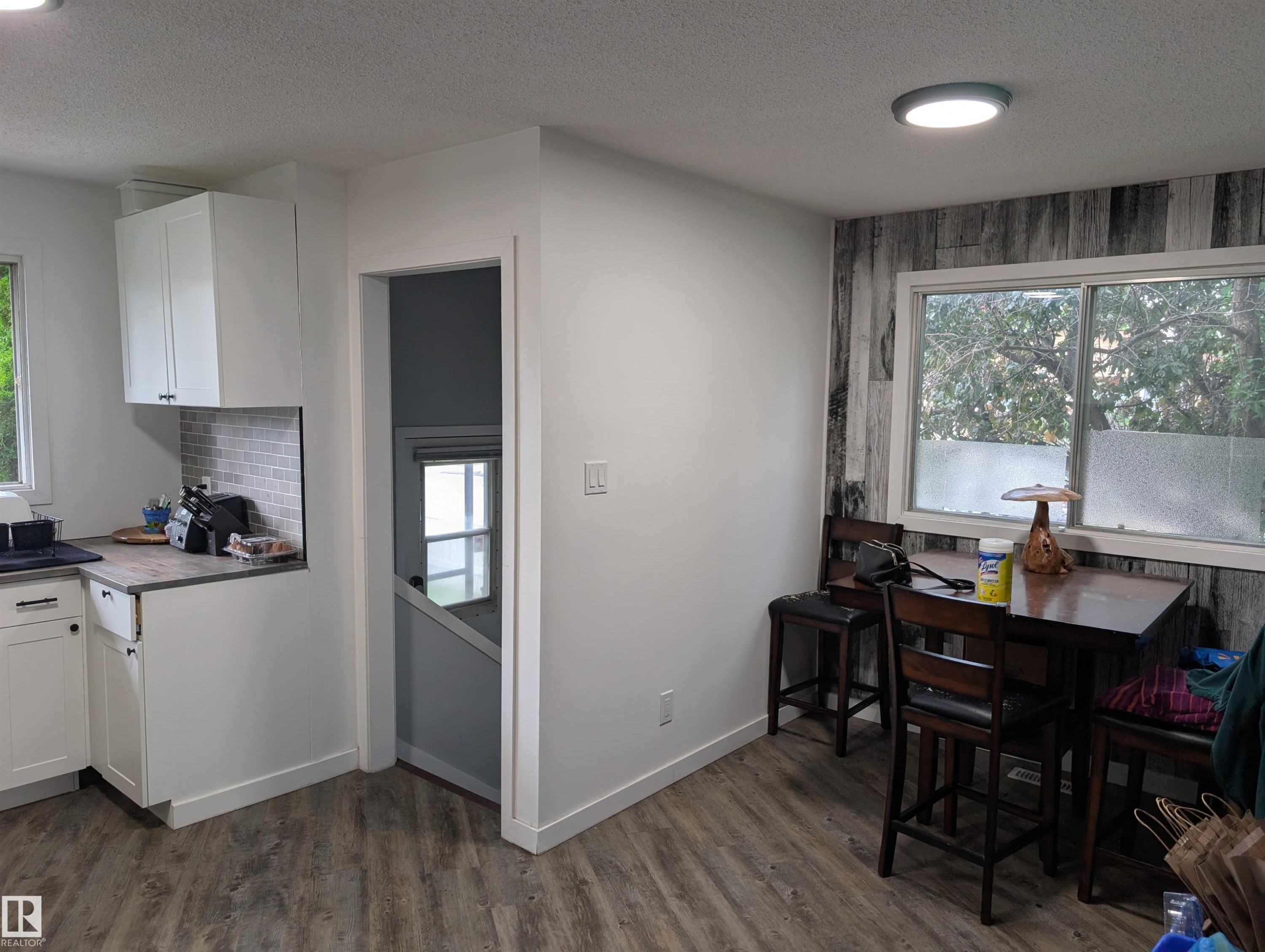Open-concept kitchen and dining area featuring wood-finish flooring - 14228 22 Street Nw, Edmonton, AB - Indoor