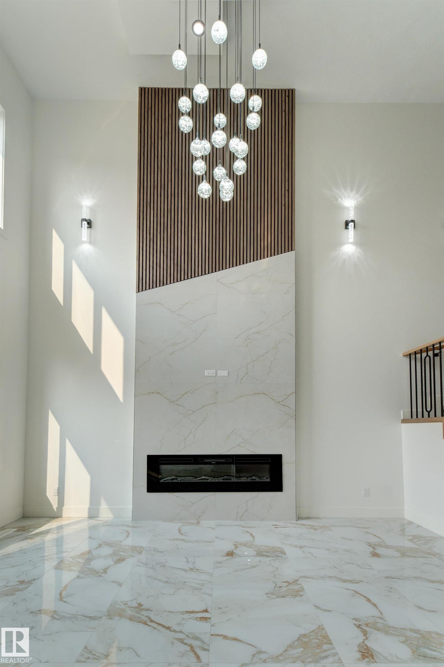 Modern fireplace wall with wood-slat detailing and large format stone-look tile - 4723 17 Avenue Sw, Edmonton, AB - Indoor Photo Showing Other Room With Fireplace