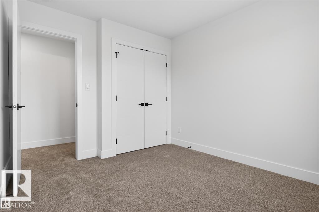 Room featuring light gray carpeting and white walls - 43 River Birch Way, St. Albert, AB - Indoor Photo Showing Other Room
