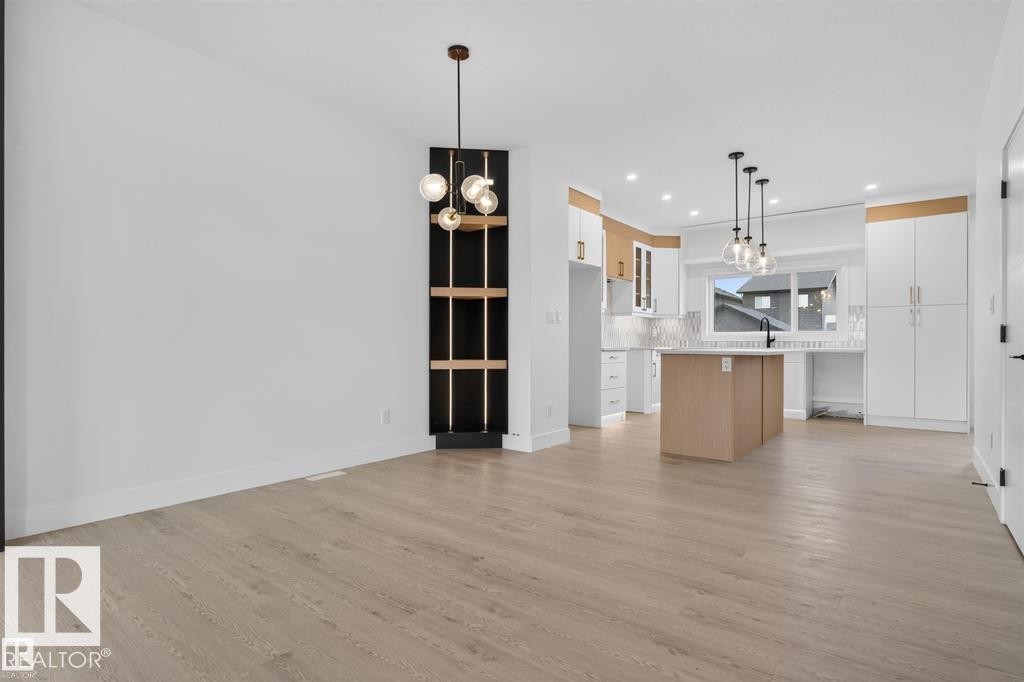 Open-concept living space with light wood-finish flooring - 43 River Birch Way, St. Albert, AB - Indoor Photo Showing Kitchen