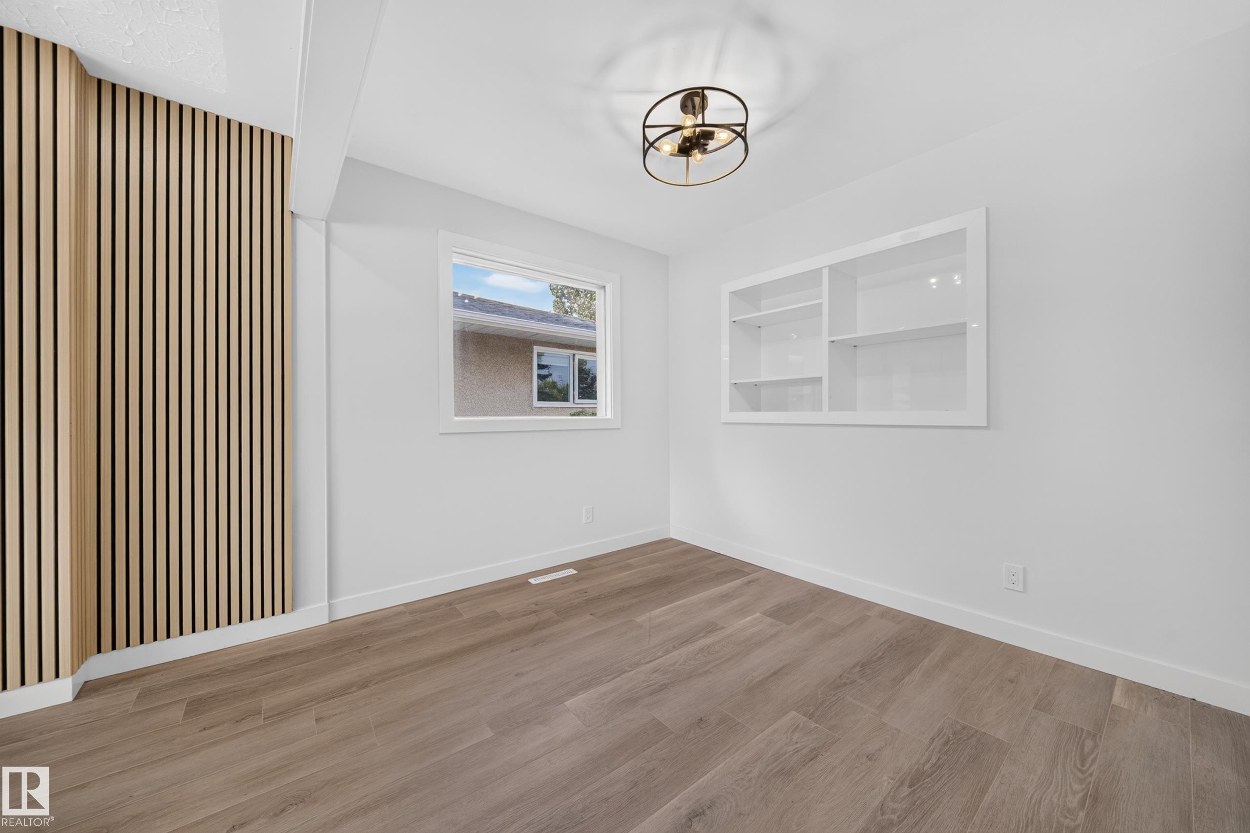 Interior space featuring wood-finish flooring and white baseboards - 5204 97A Avenue Nw, Edmonton, AB - Indoor Photo Showing Other Room