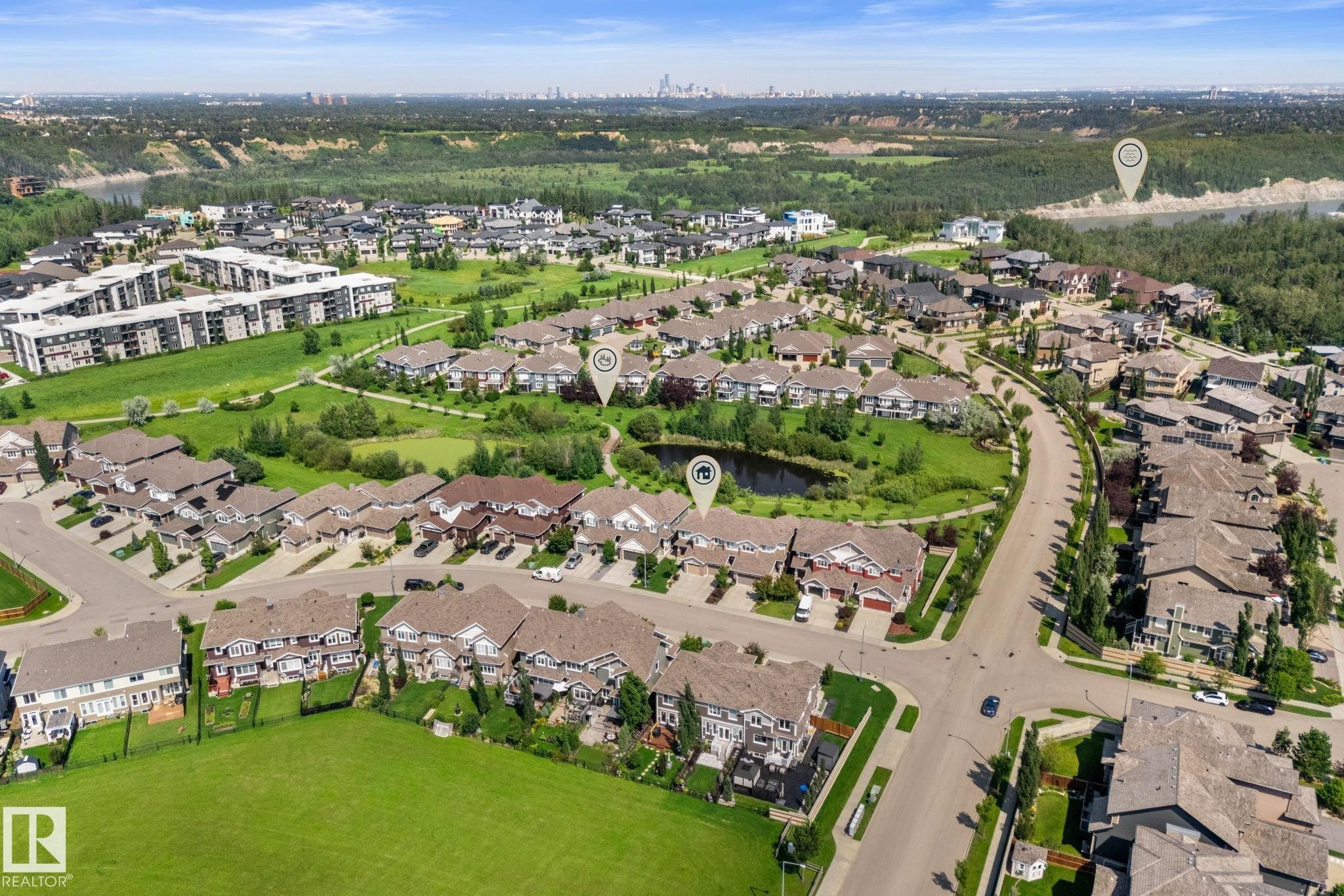 Aerial overview of a residential development featuring single-family homes and multi-unit buildings - 3413 Cameron Heights Cove Nw, Edmonton, AB - Outdoor With View