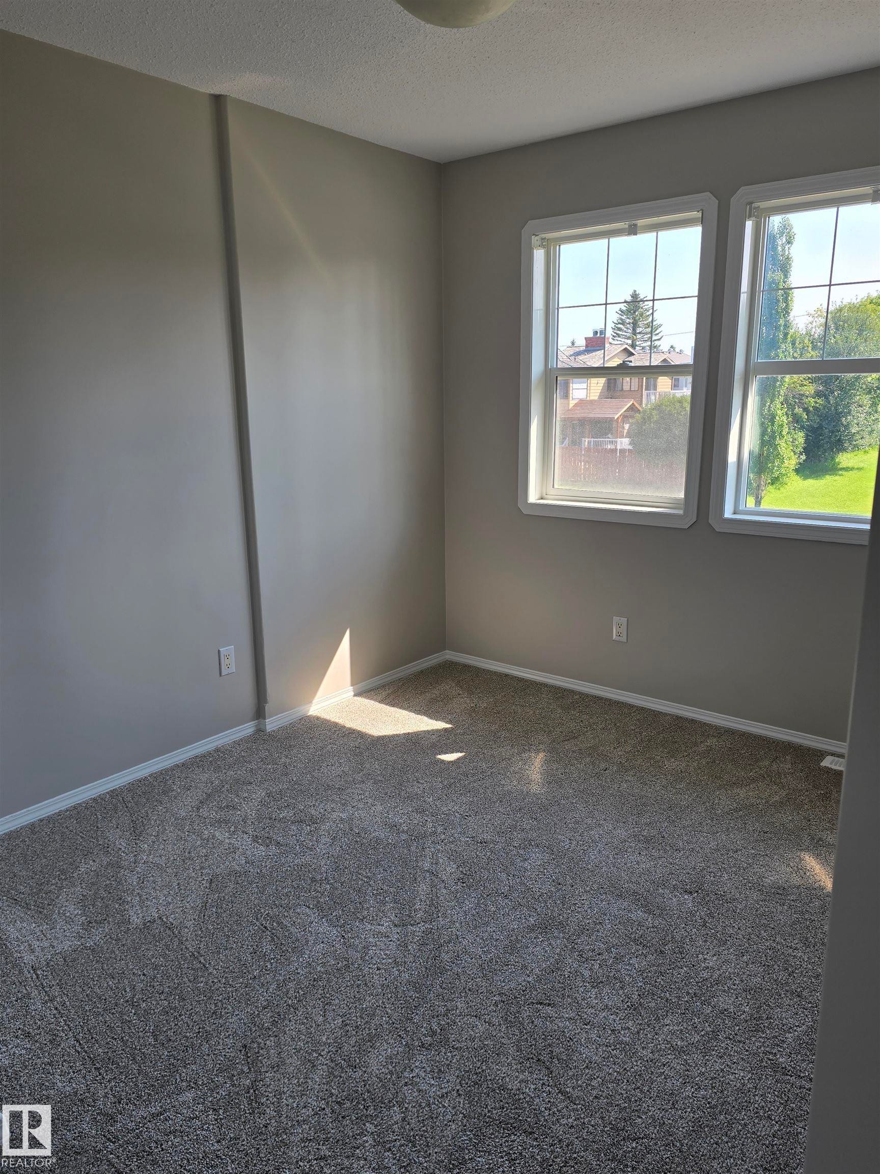 Room featuring neutral-toned walls and plush gray carpeting - 4120 47 Street, Drayton Valley, AB - Indoor Photo Showing Other Room