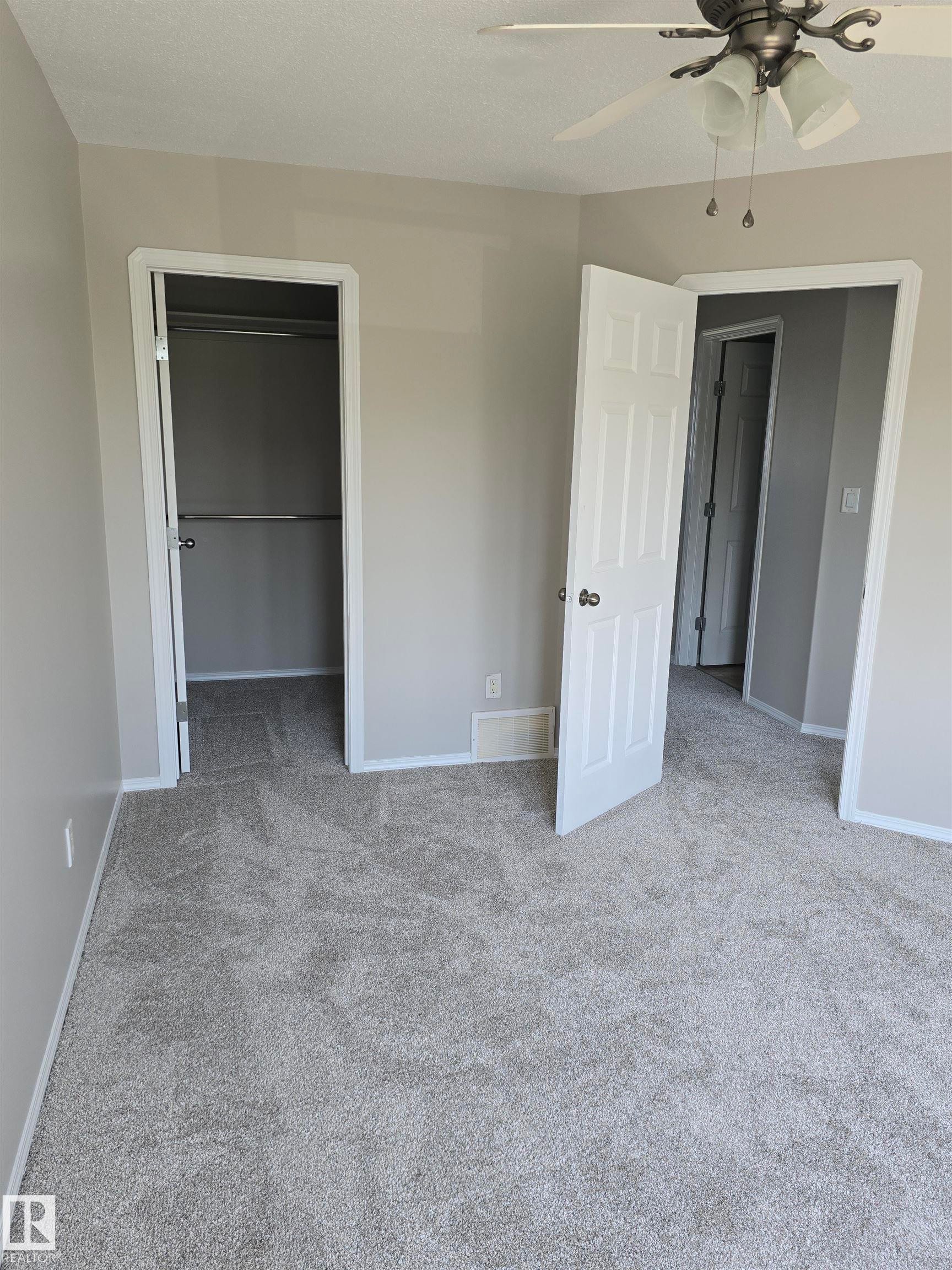 Room featuring light gray walls, white trim, and gray carpeting - 4120 47 Street, Drayton Valley, AB - Indoor