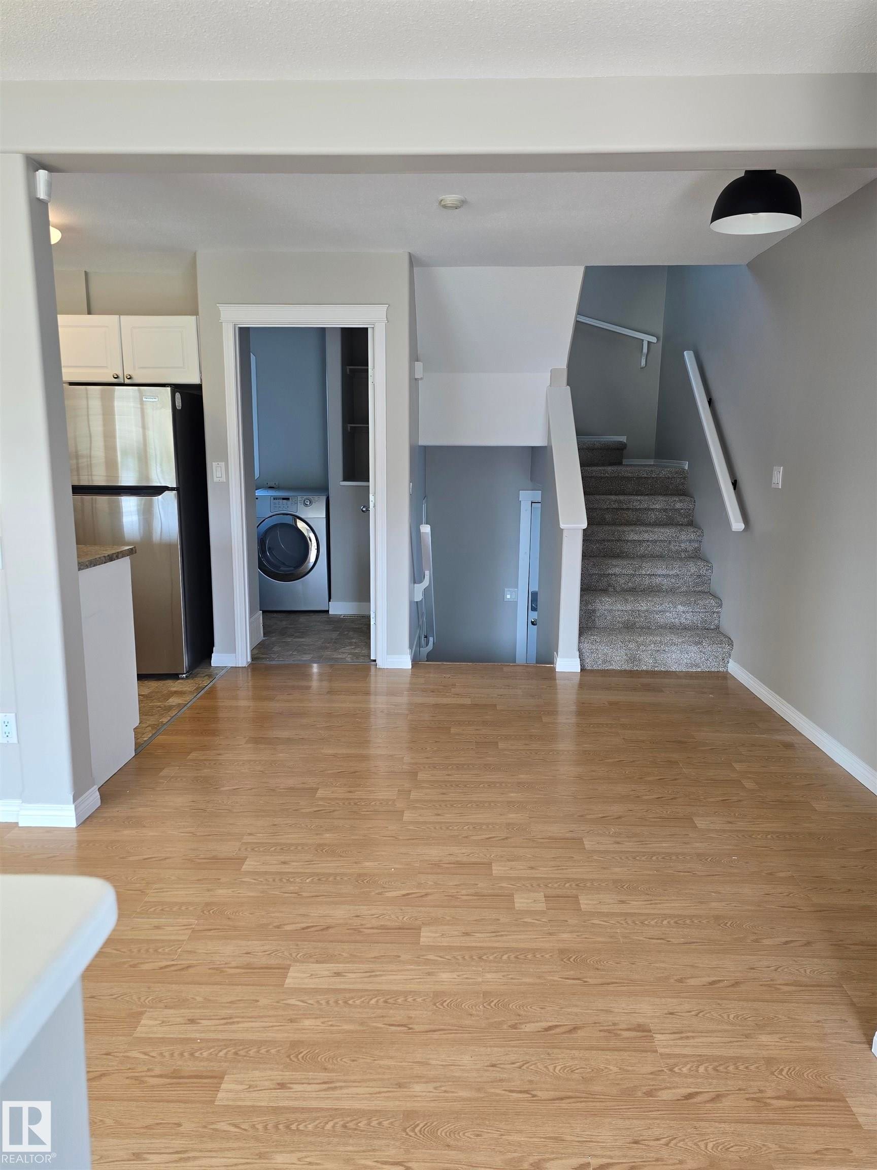 Open concept interior featuring light wood-finish flooring - 4120 47 Street, Drayton Valley, AB - Indoor Photo Showing Other Room