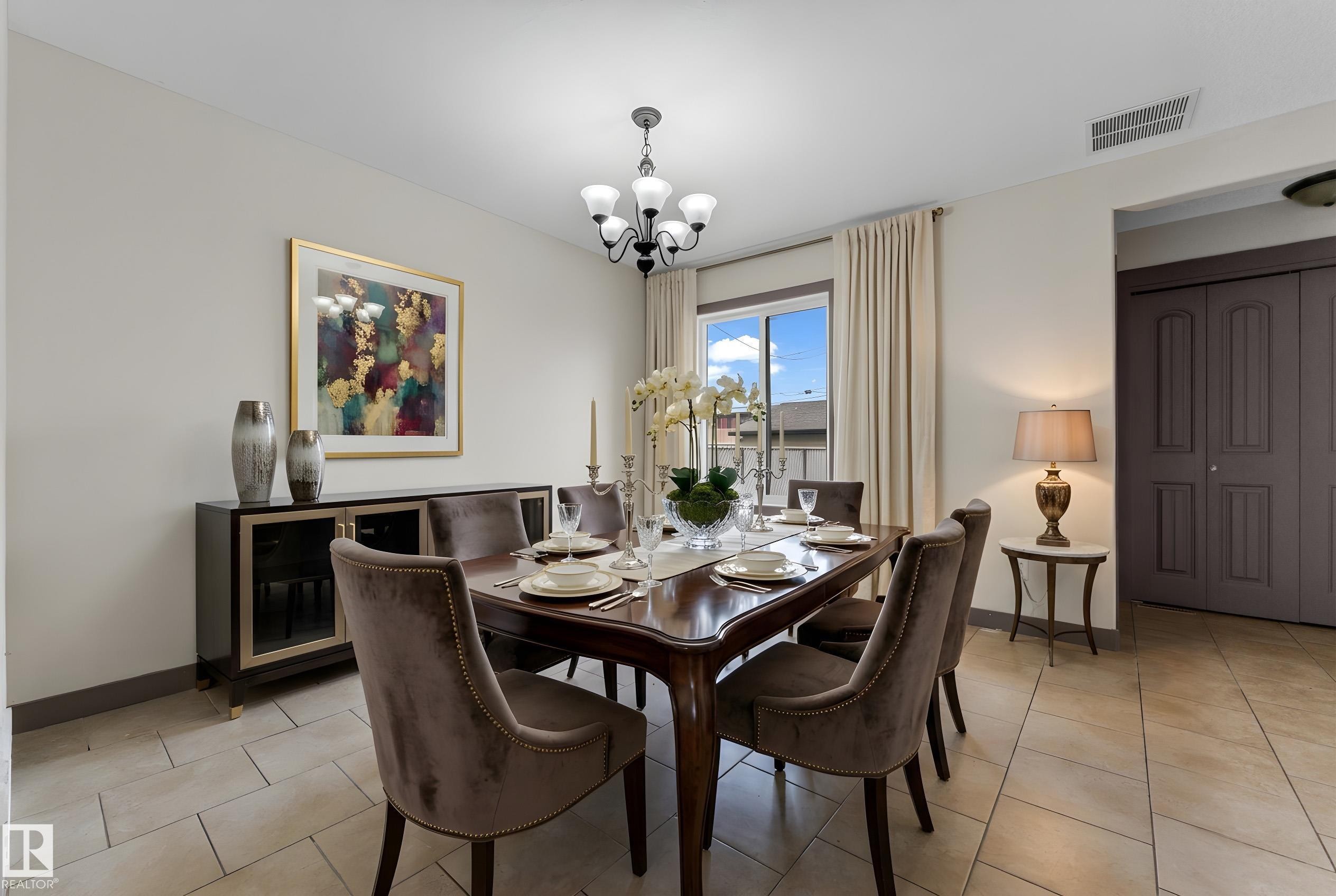 Dining area featuring ceramic tile flooring, a multi-pane window with drapes, and a black chandelier - 11817 37 Street Nw, Edmonton, AB - Indoor Photo Showing Dining Room