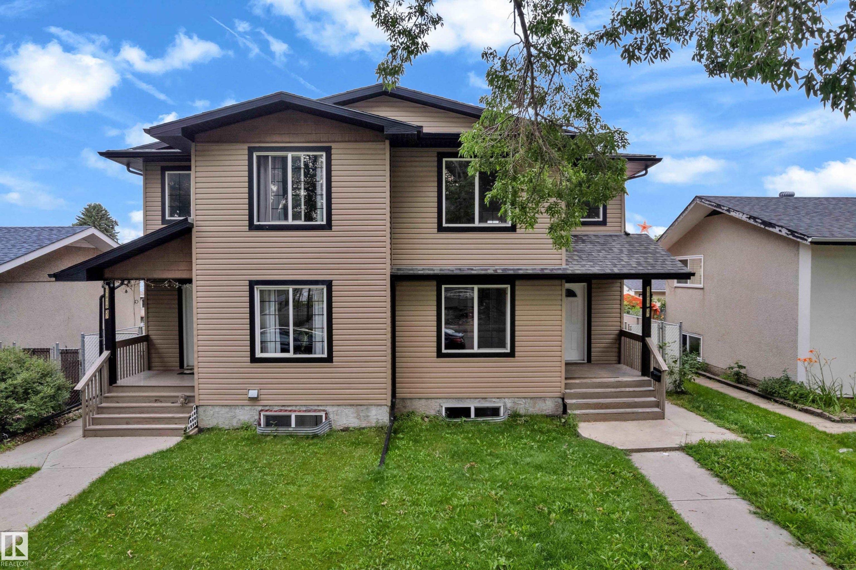 Two-story duplex featuring tan siding and black trim around windows - 11817 37 Street Nw, Edmonton, AB - Outdoor With Facade