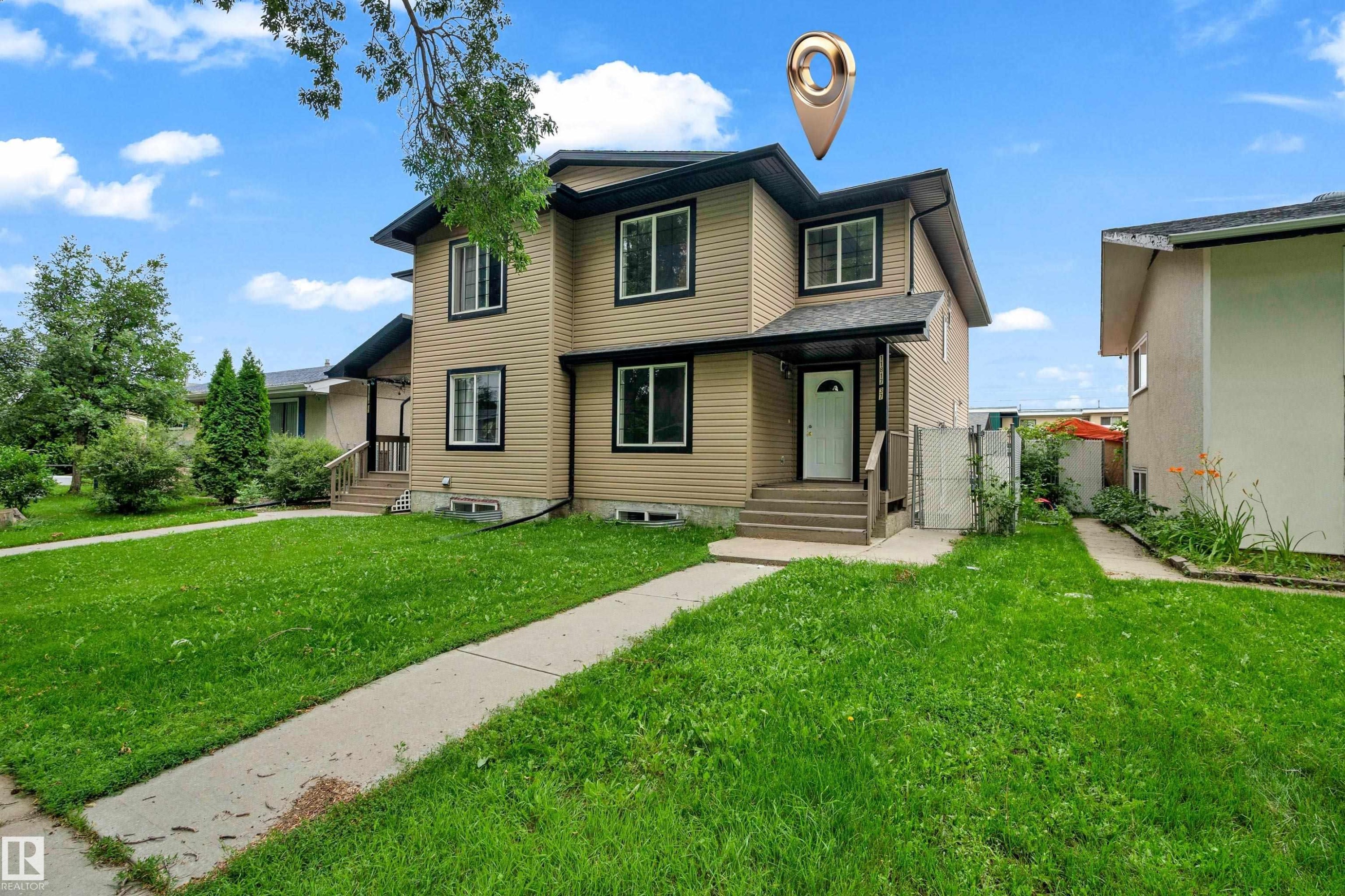 Two-story property featuring tan horizontal siding with dark trim accents - 11817 37 Street Nw, Edmonton, AB - Outdoor With Facade