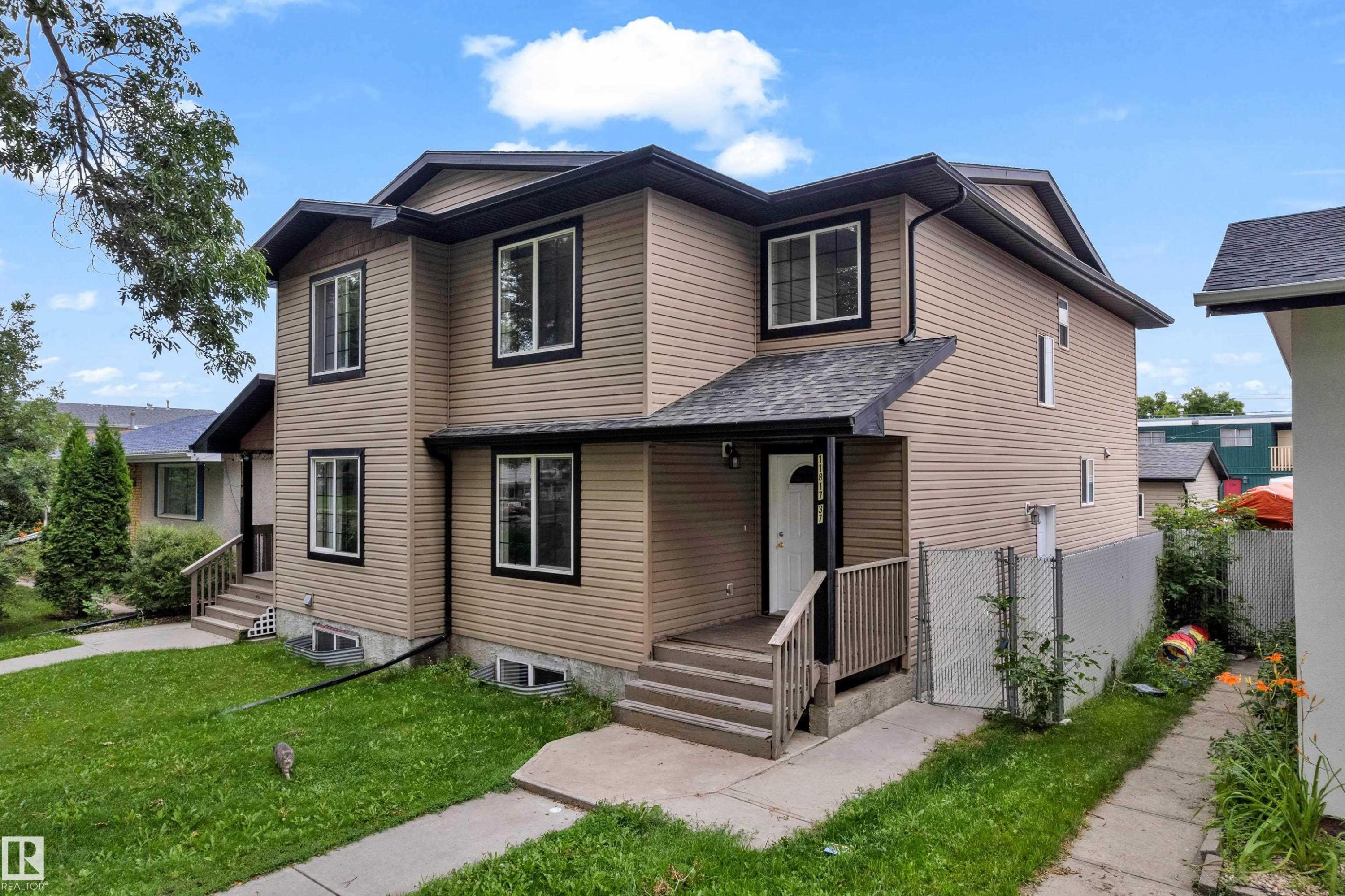 Two-story exterior with light brown siding and contrasting dark trim - 11817 37 Street Nw, Edmonton, AB - Outdoor