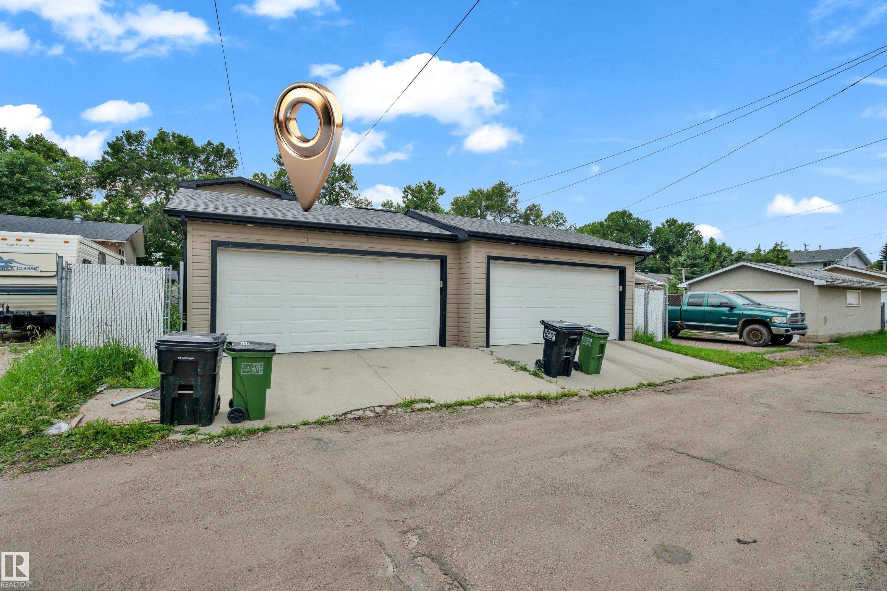 Two-car garage with tan horizontal siding and white garage doors - 11817 37 Street Nw, Edmonton, AB - Outdoor With Exterior