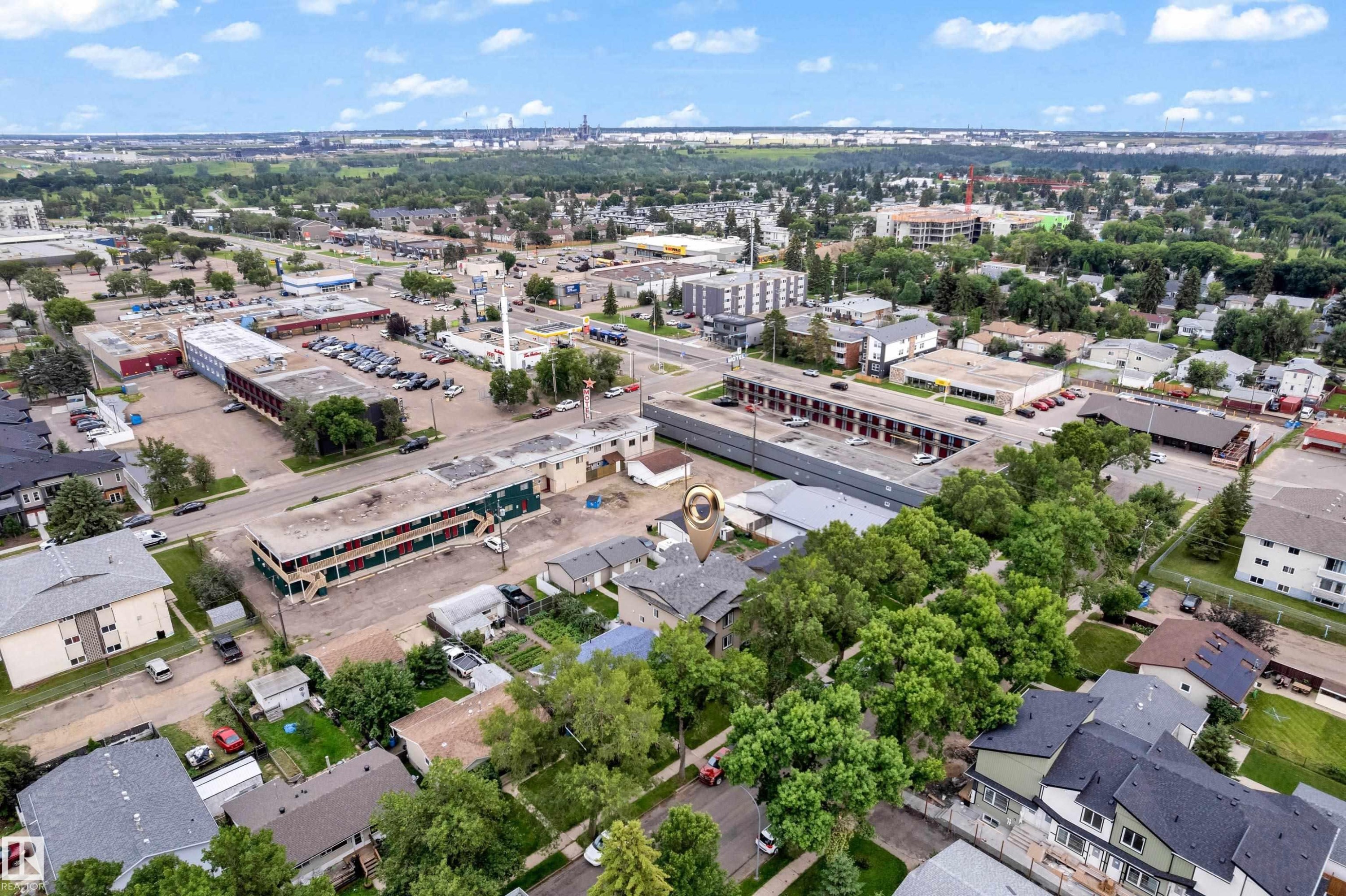 Aerial perspective showcasing an urban environment with mixed-use buildings, residential properties, and mature trees - 11817 37 Street Nw, Edmonton, AB - Outdoor With View