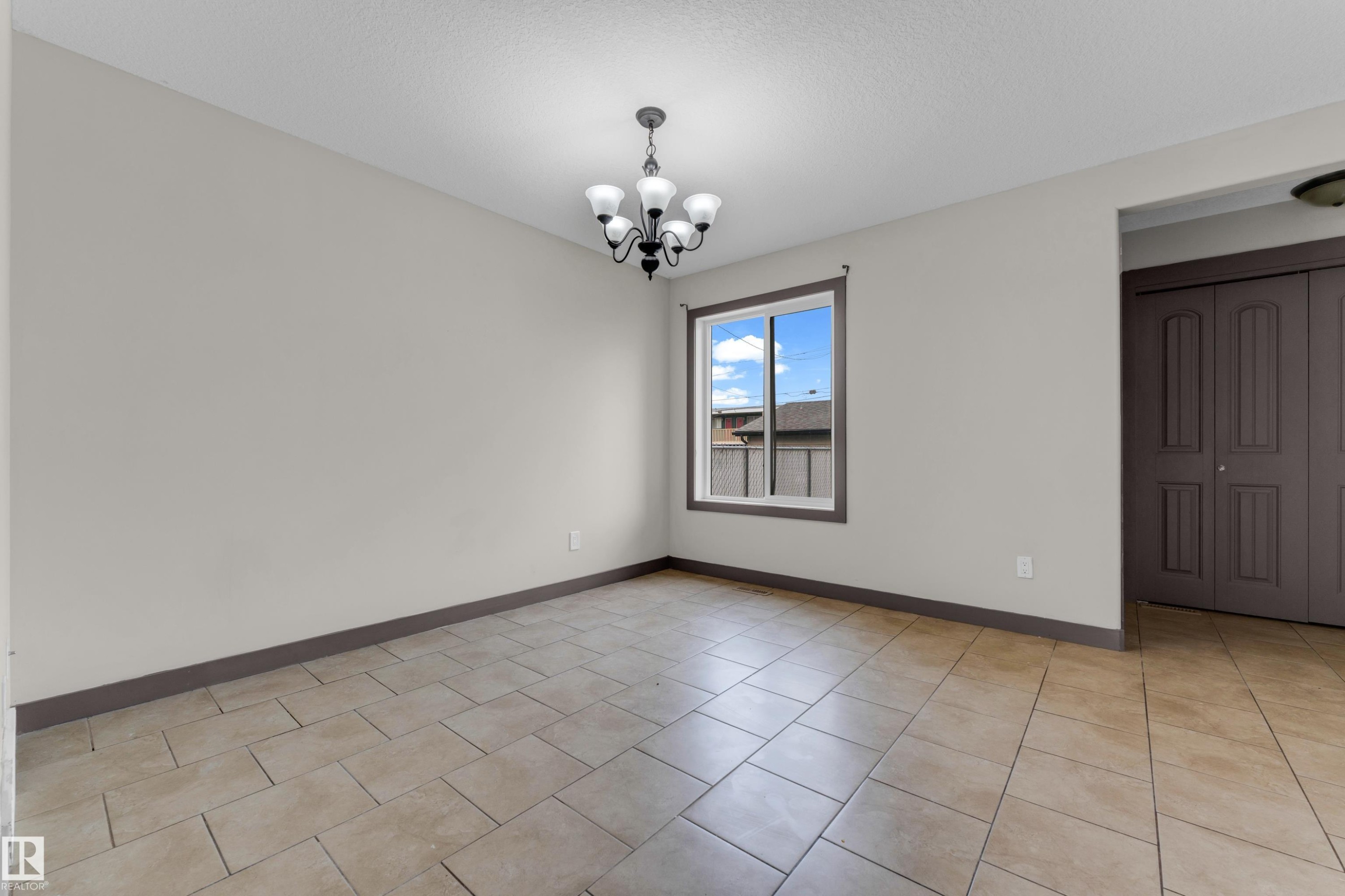 Neutral-toned walls complement the light-colored tile flooring - 11817 37 Street Nw, Edmonton, AB - Indoor Photo Showing Other Room