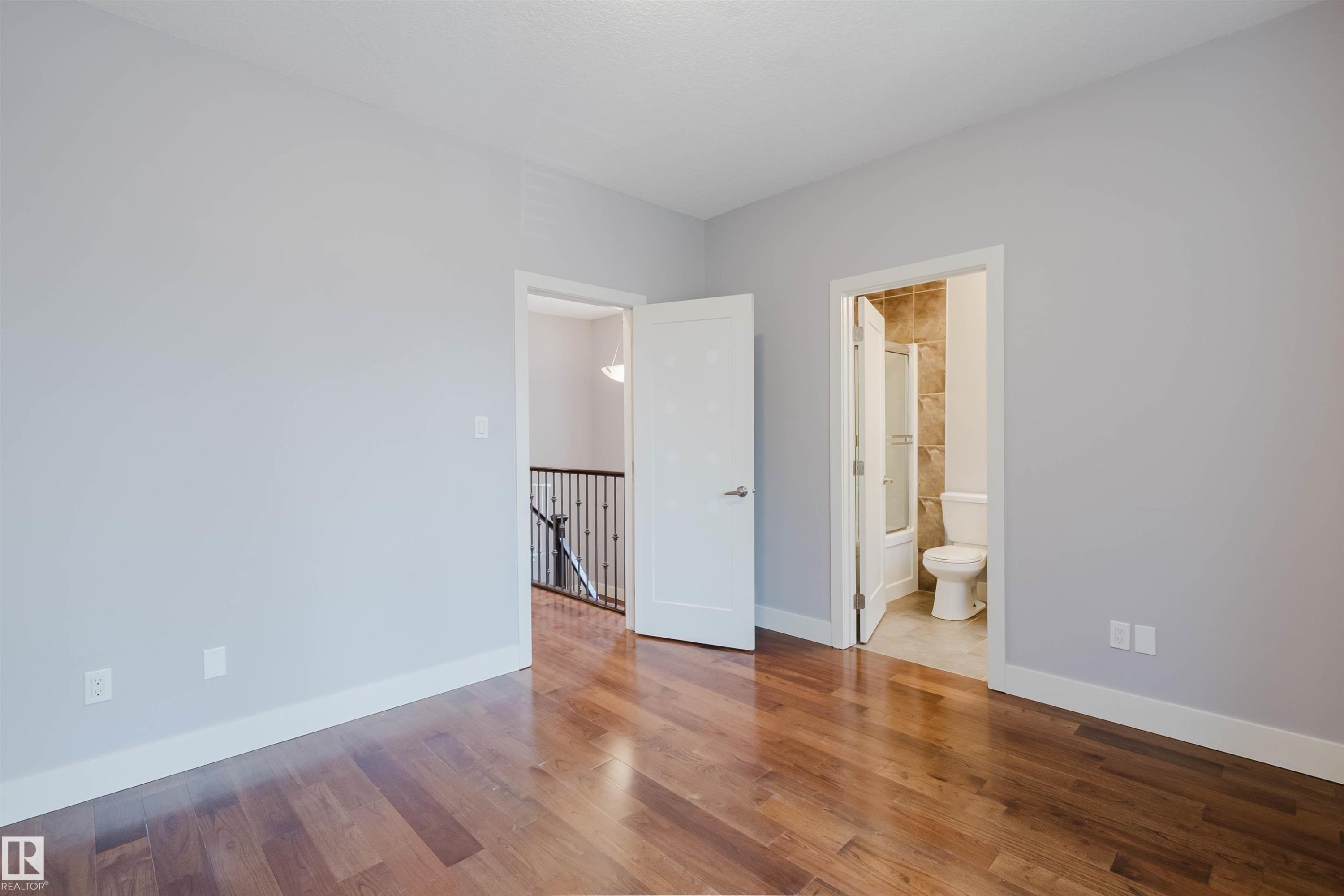 Room featuring wood-finish flooring and light gray walls - 10626 81 Avenue Nw, Edmonton, AB - Indoor Photo Showing Other Room